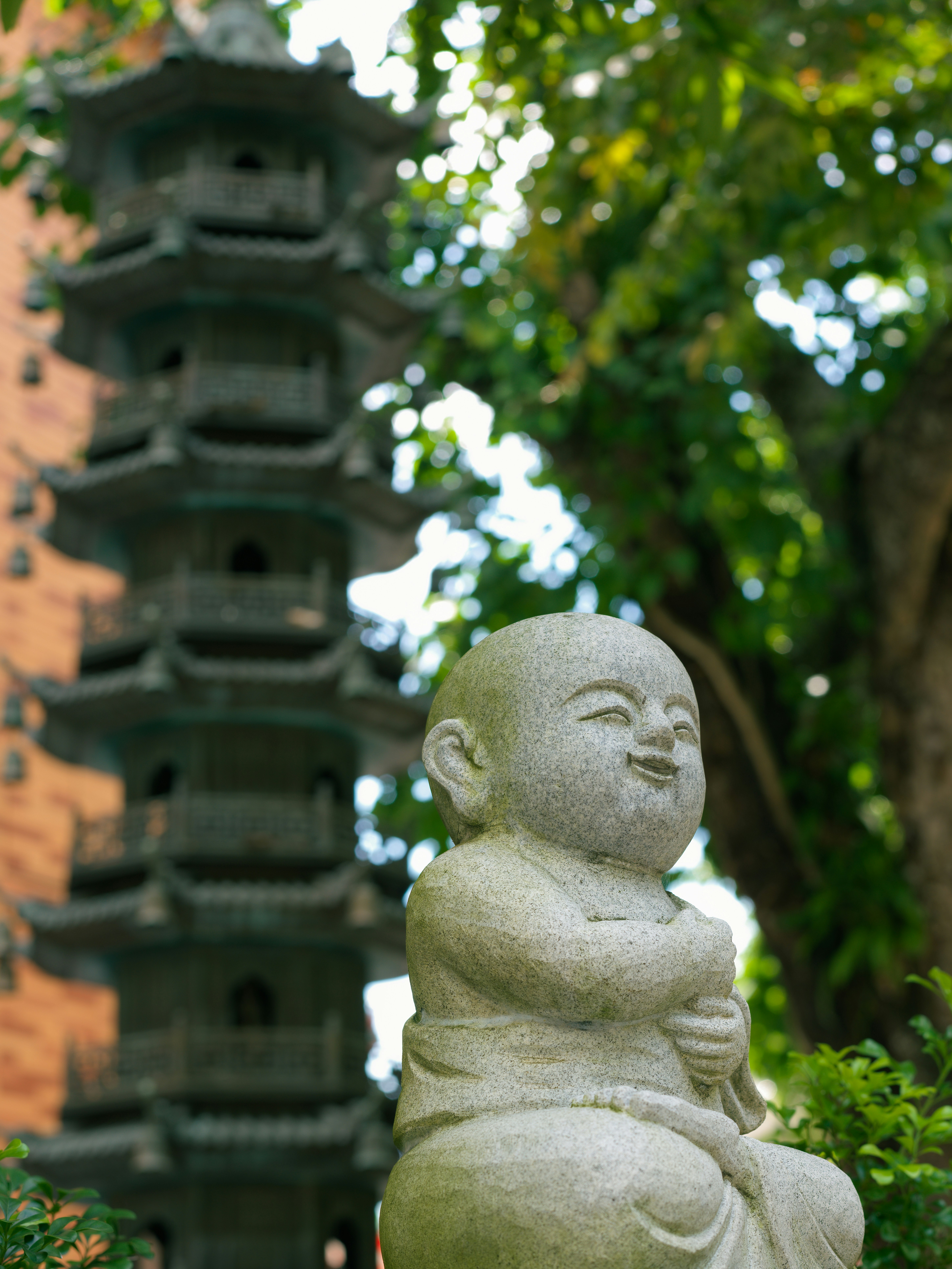 A statue of a buddha in front of a pagoda