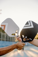 A couple of people that are holding some tennis rackets