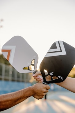 A couple of people that are holding some tennis rackets