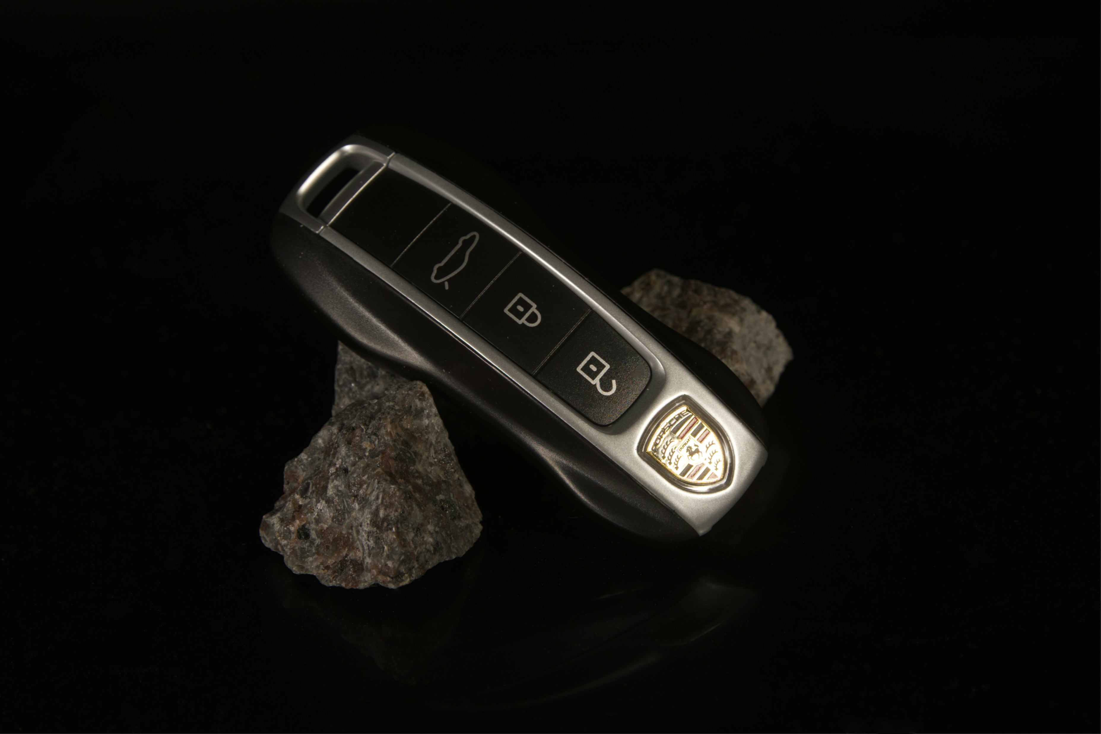 TWAAO A cell phone sitting on top of a pile of rocks