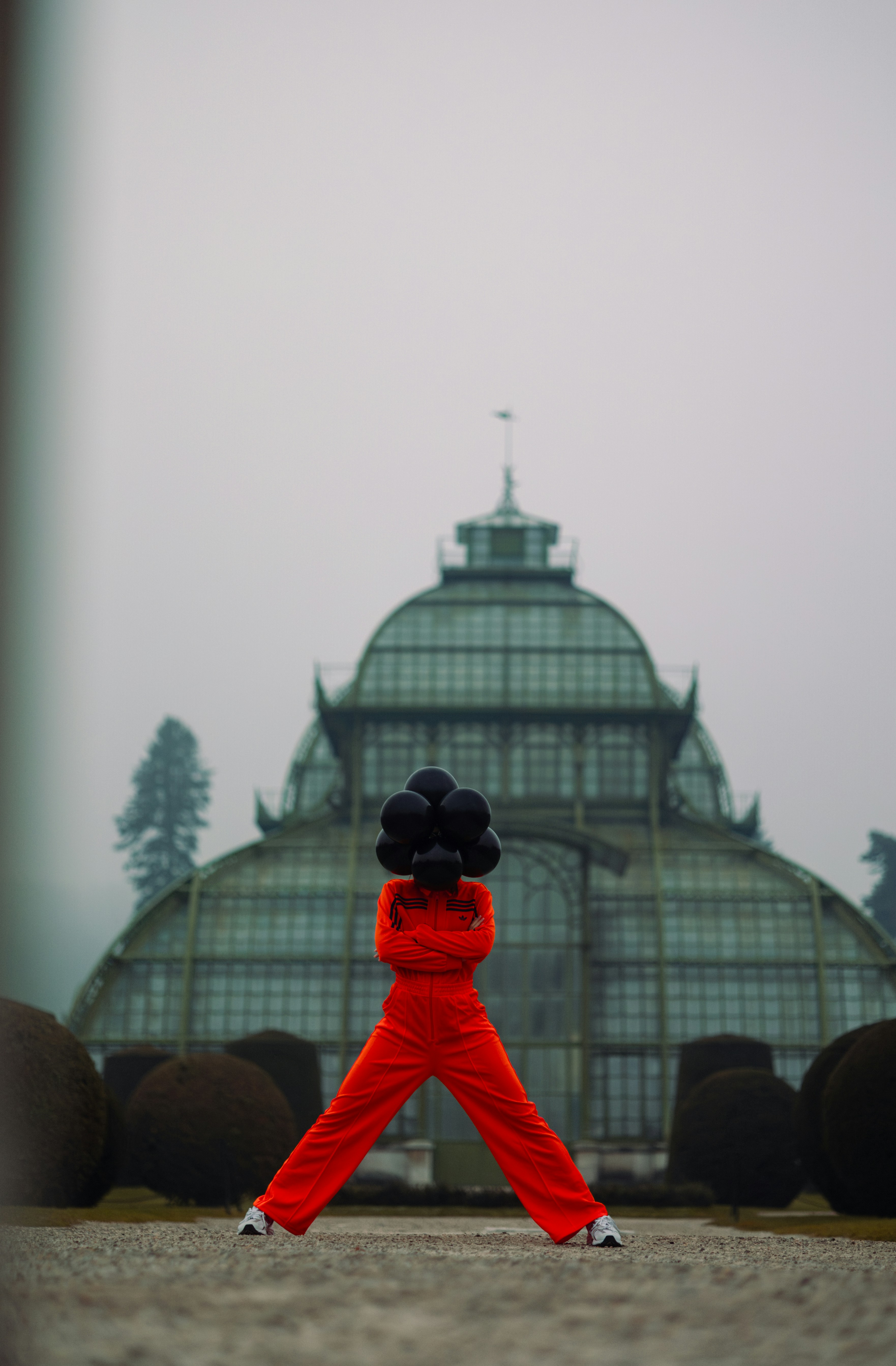 A person in a red outfit is holding a black object