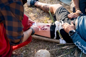 A man laying on the ground with a broken leg