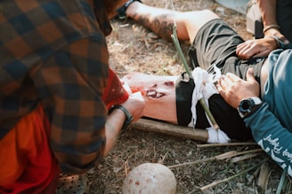 A group of men standing around a man laying on the ground