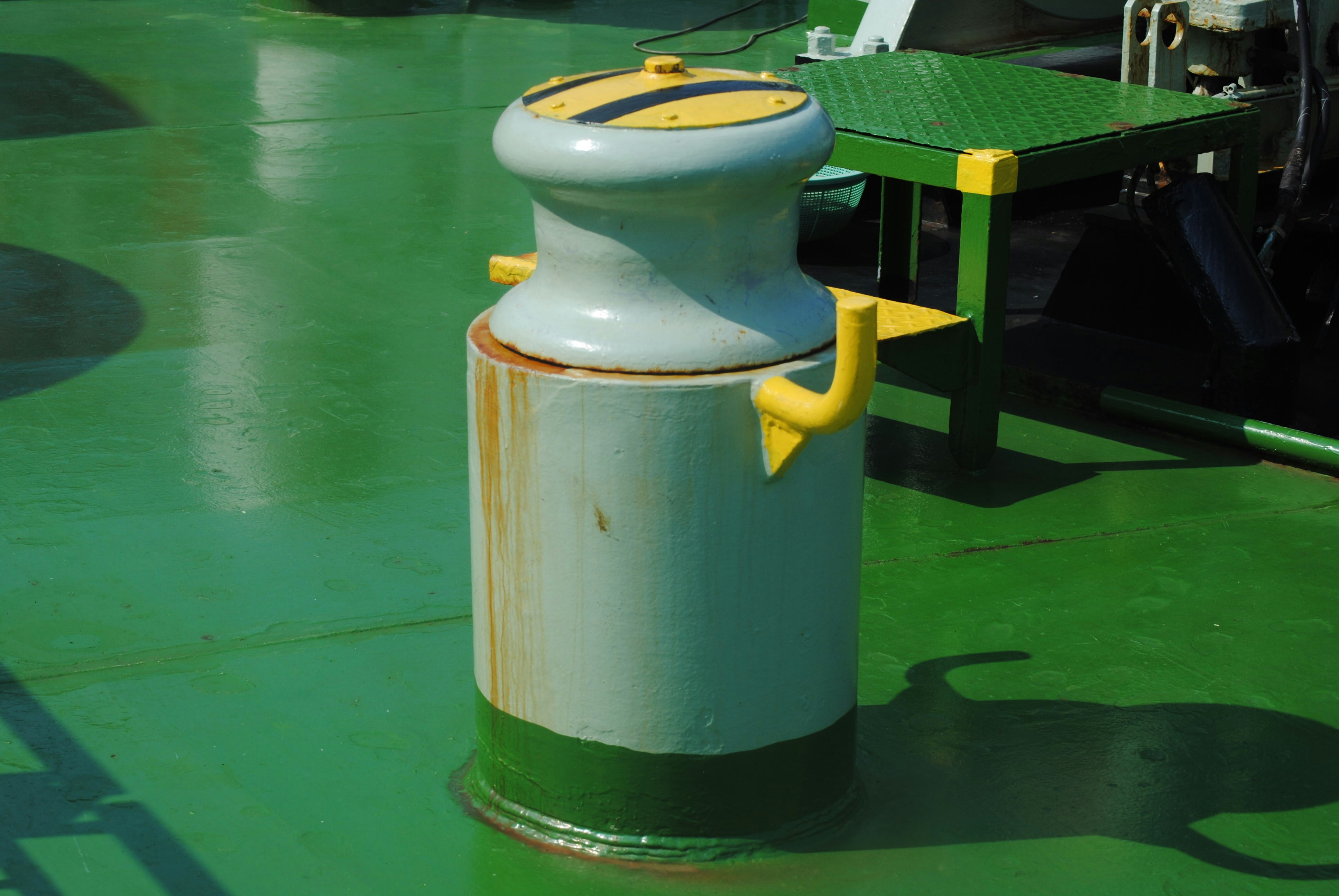 A white and yellow object sitting on top of a green floor