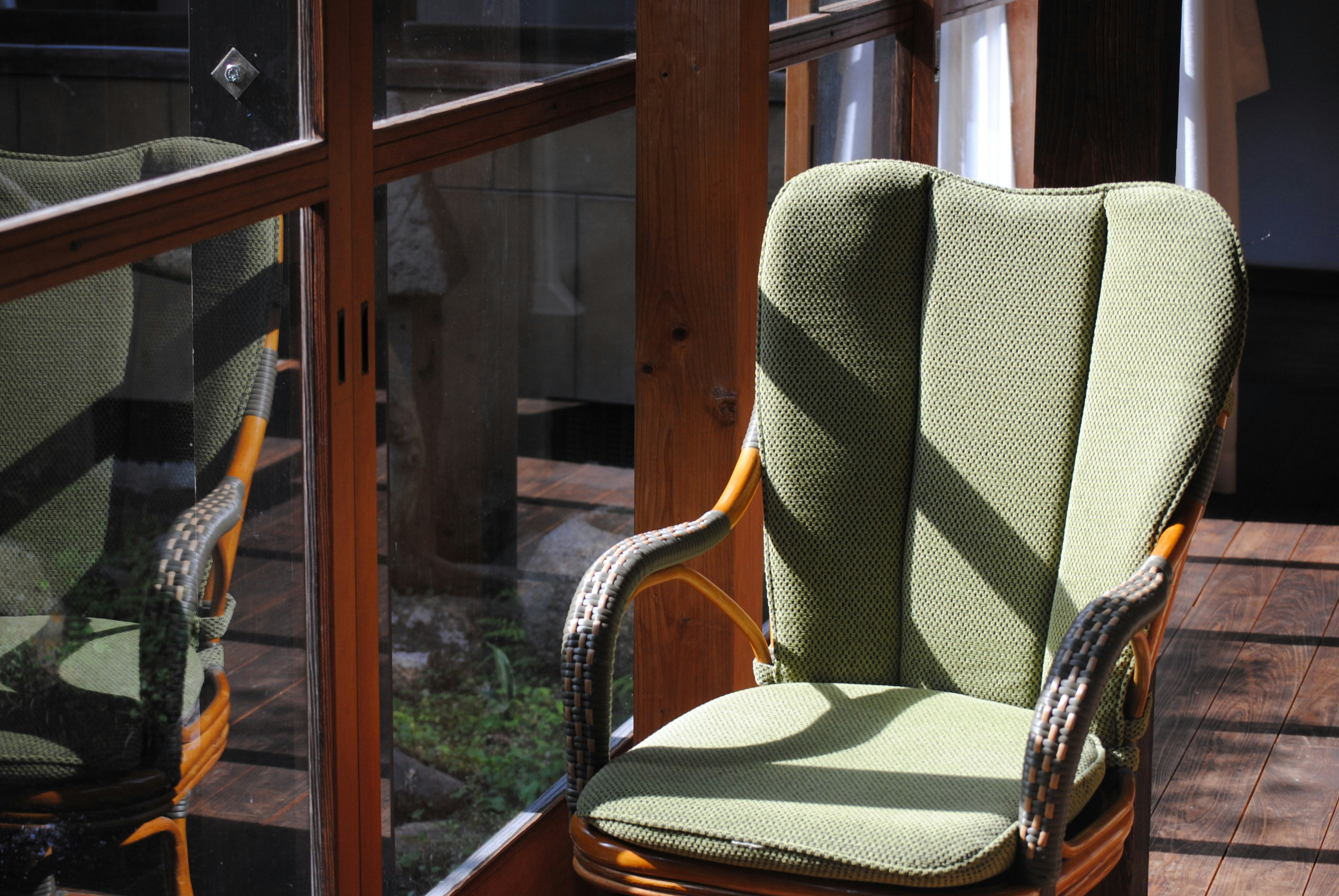 A green chair sitting on top of a wooden table