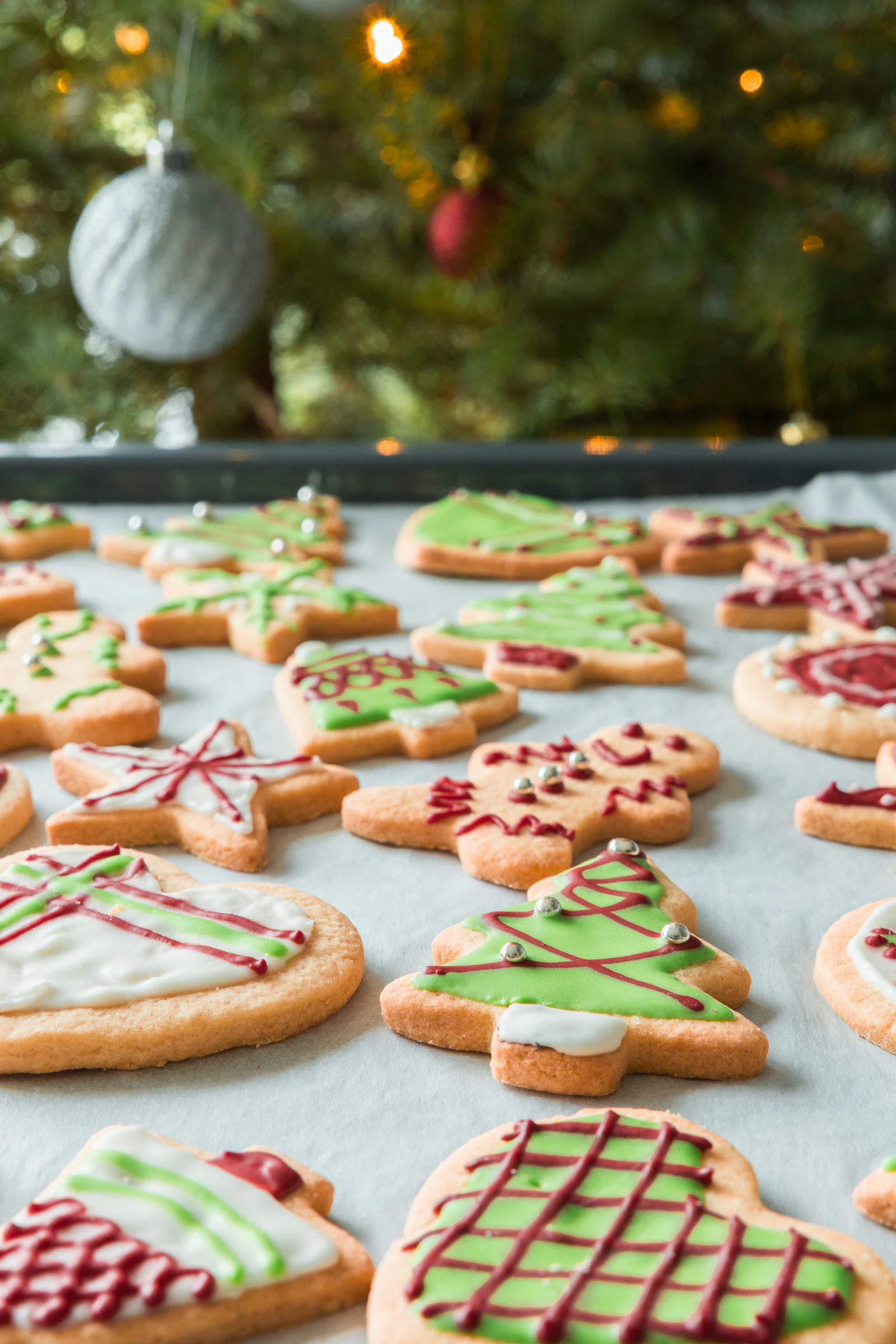 Individually decorated royal icing custom cookies arranged together in a coordinated color palette