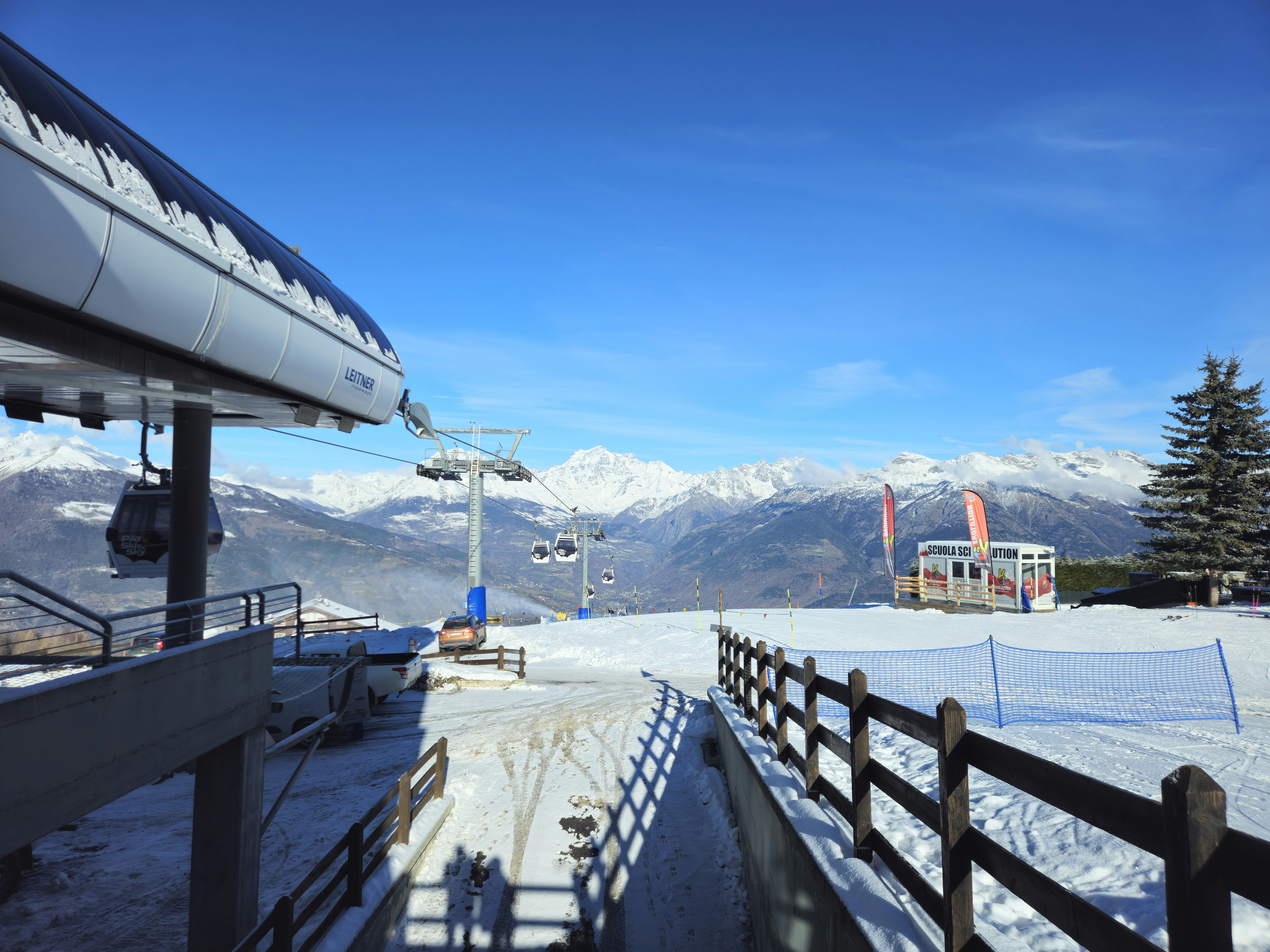 A snow covered ski slope with a ski lift in the background