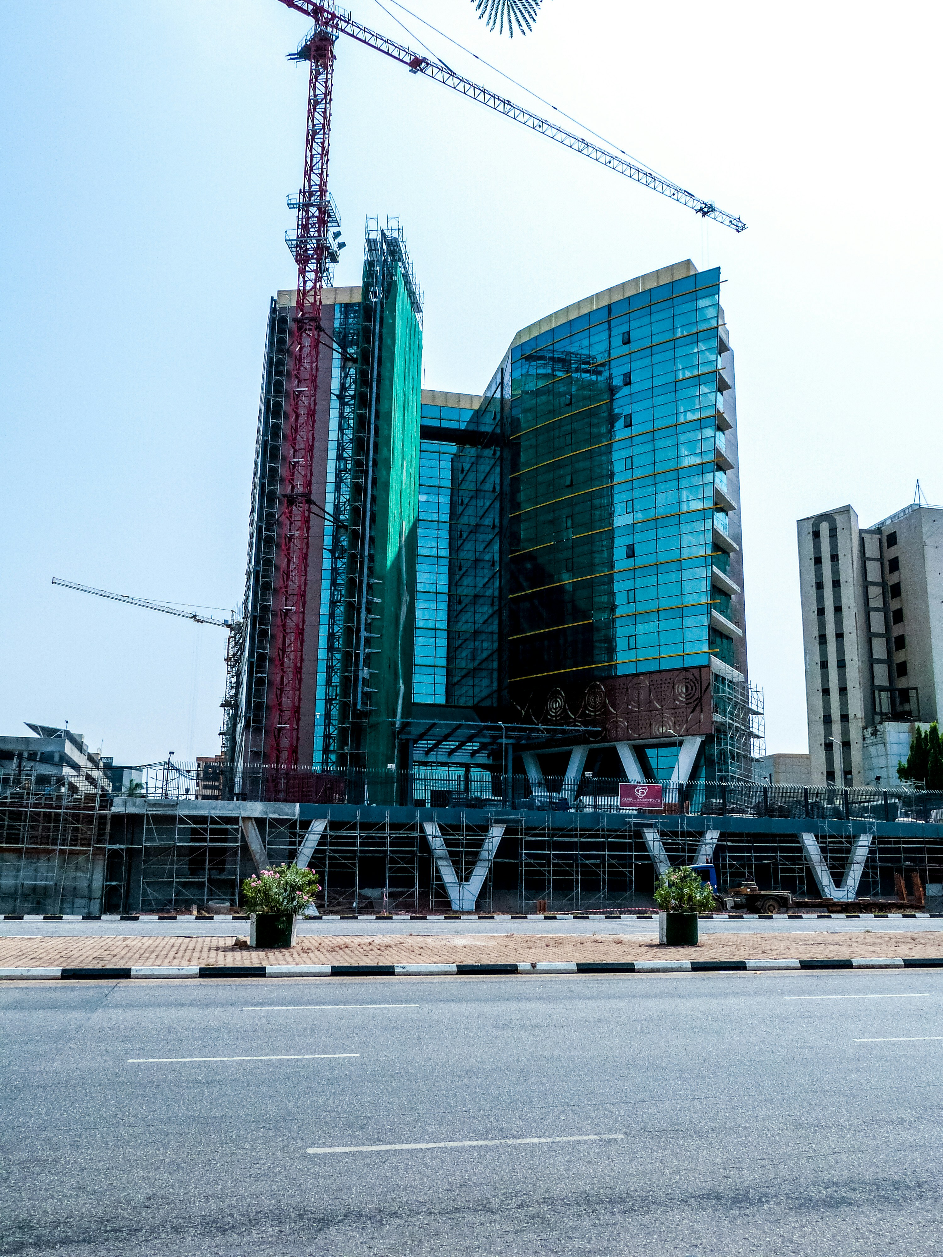A man riding a skateboard down a street next to tall buildings