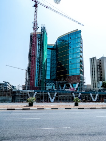 A man riding a skateboard down a street next to tall buildings