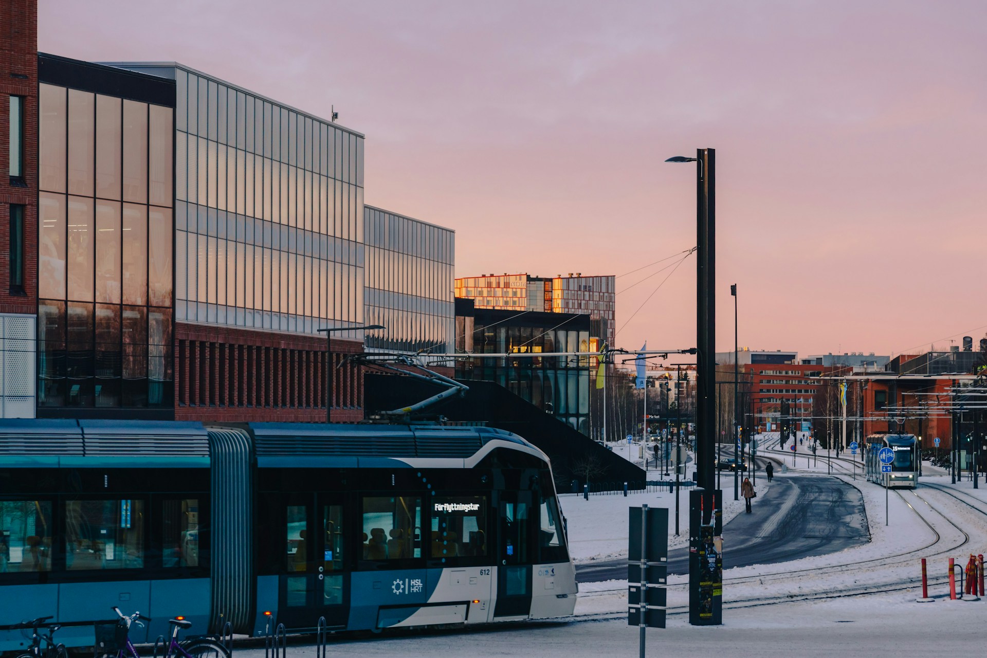 A city bus driving down a snow covered street