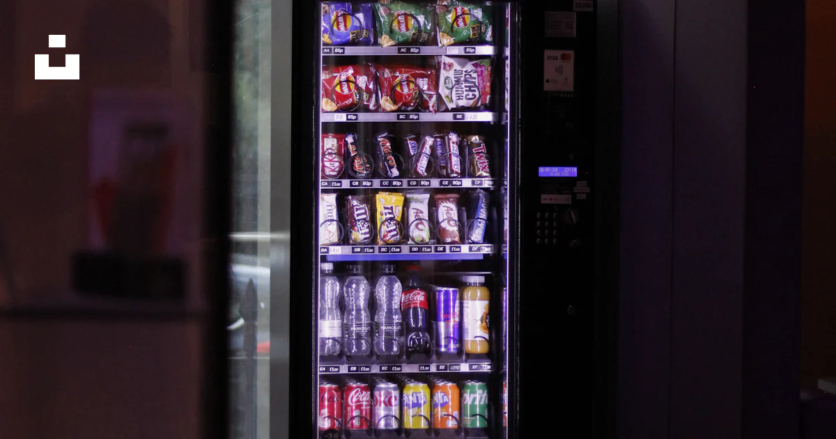 A vending machine sitting next to a window photo – Free London Image on ...