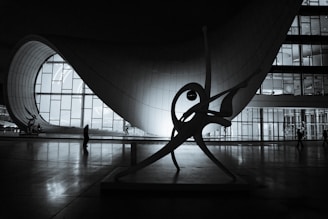 A black and white photo of a sculpture in a building