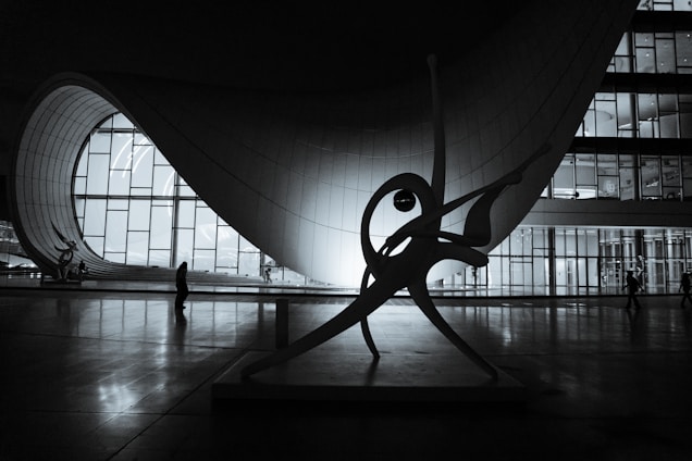 A black and white photo of a sculpture in a building