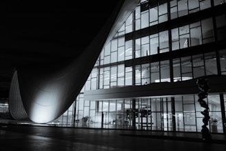 A tall building with lots of windows at night