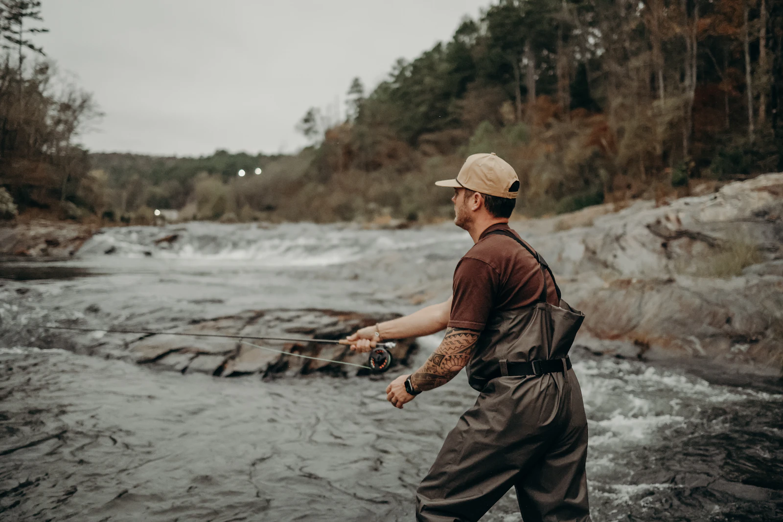 A person standing on a rock in a river