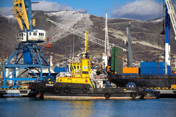 A yellow and blue boat in a body of water