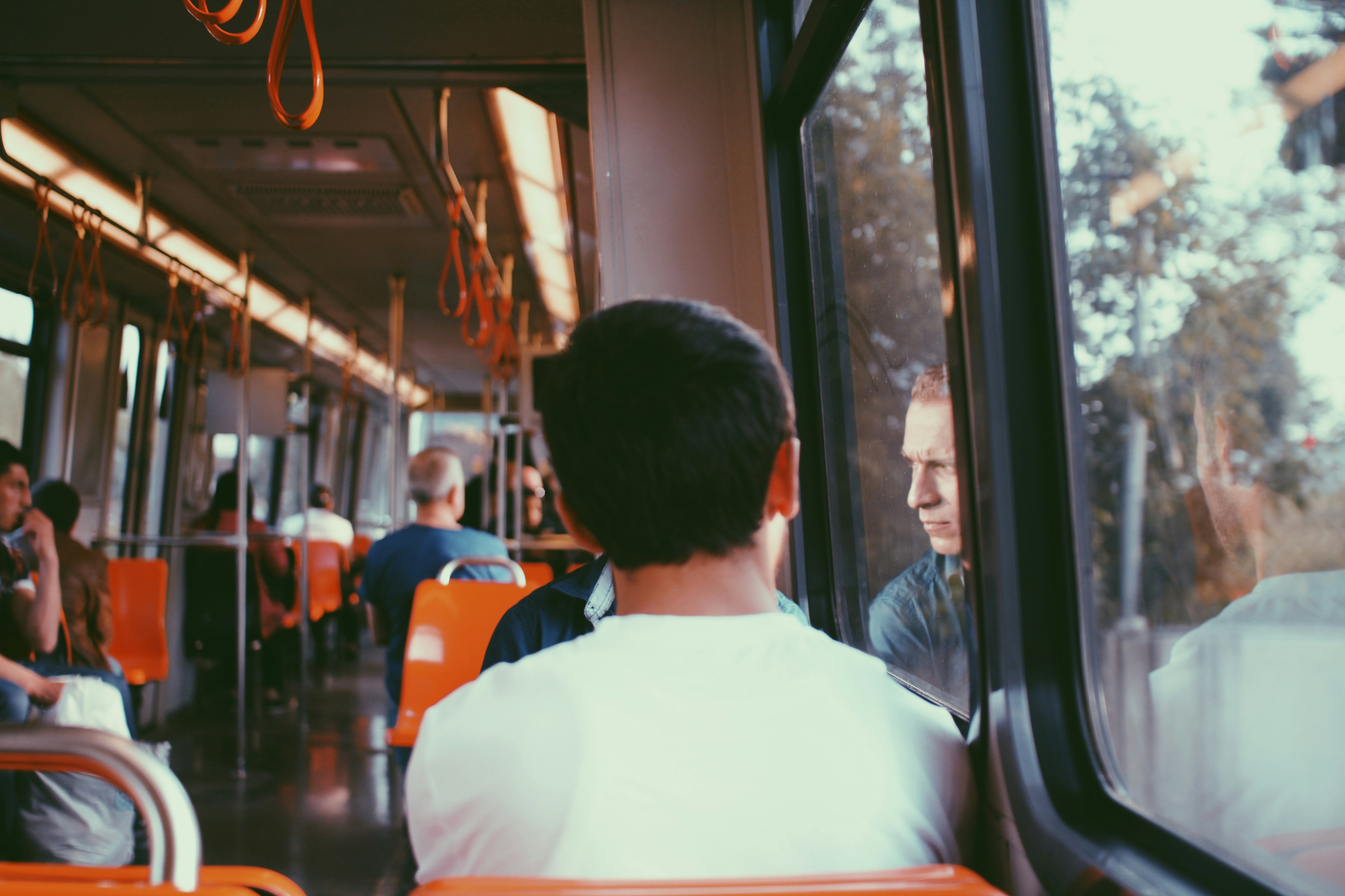 A man sitting on a bus looking out the window