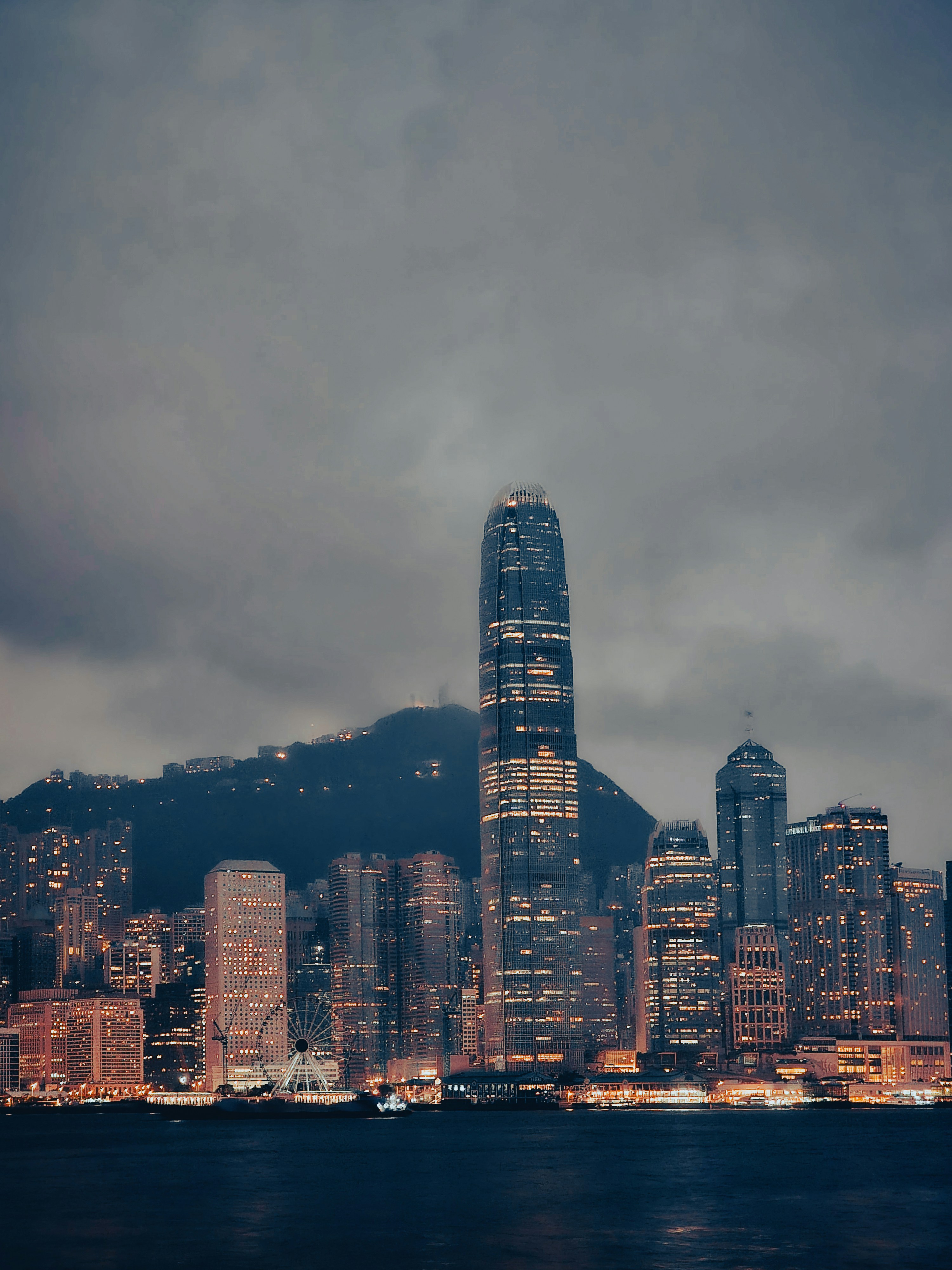 Dark atmospheric financial district with illuminated skyscrapers, dramatic city lighting, deep navy sky, cinematic institutional setting