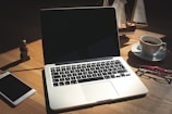 A laptop computer sitting on top of a wooden desk