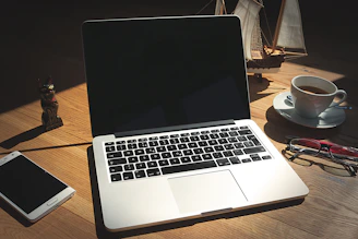 A laptop computer sitting on top of a wooden desk