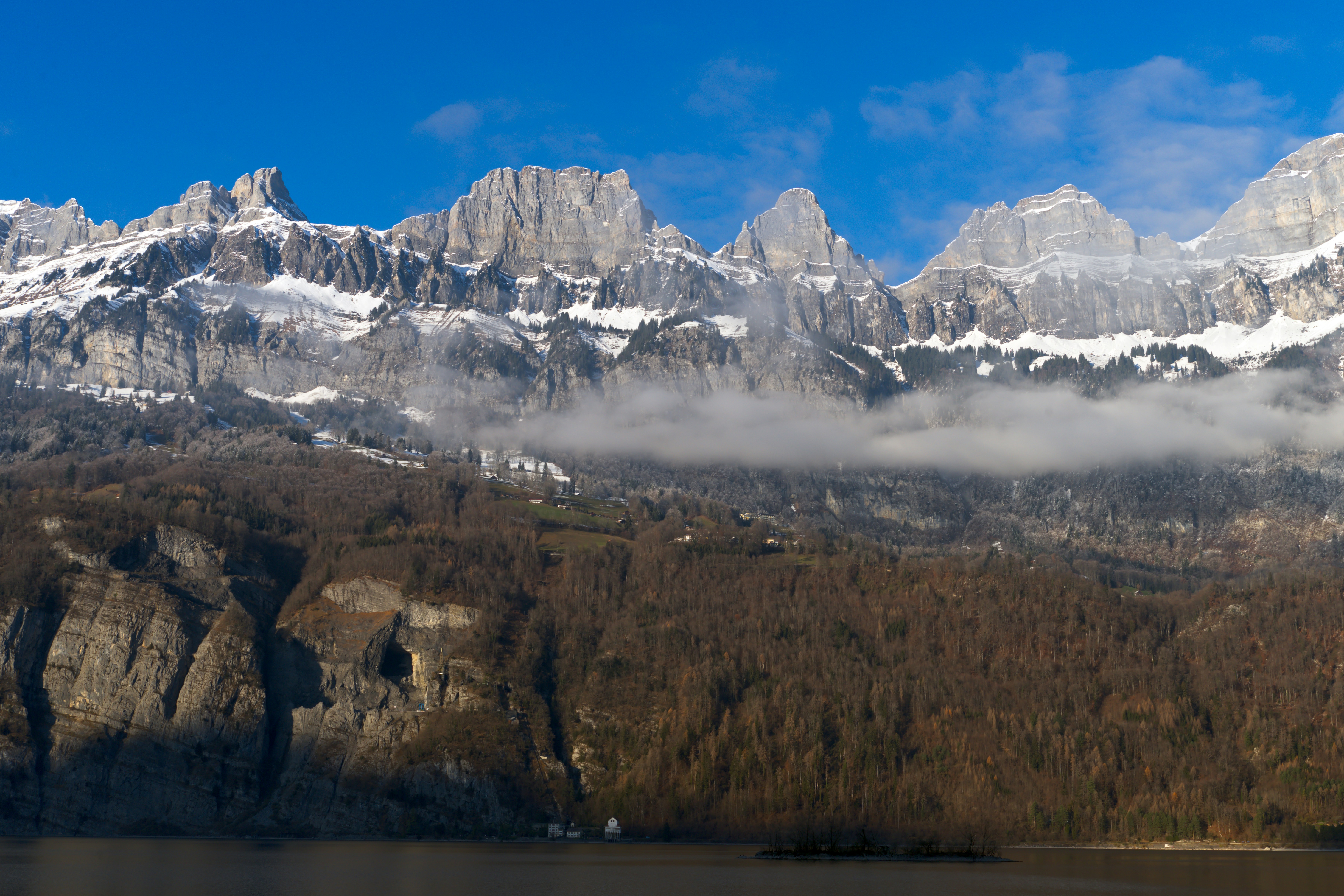 The mountains are covered in snow and clouds