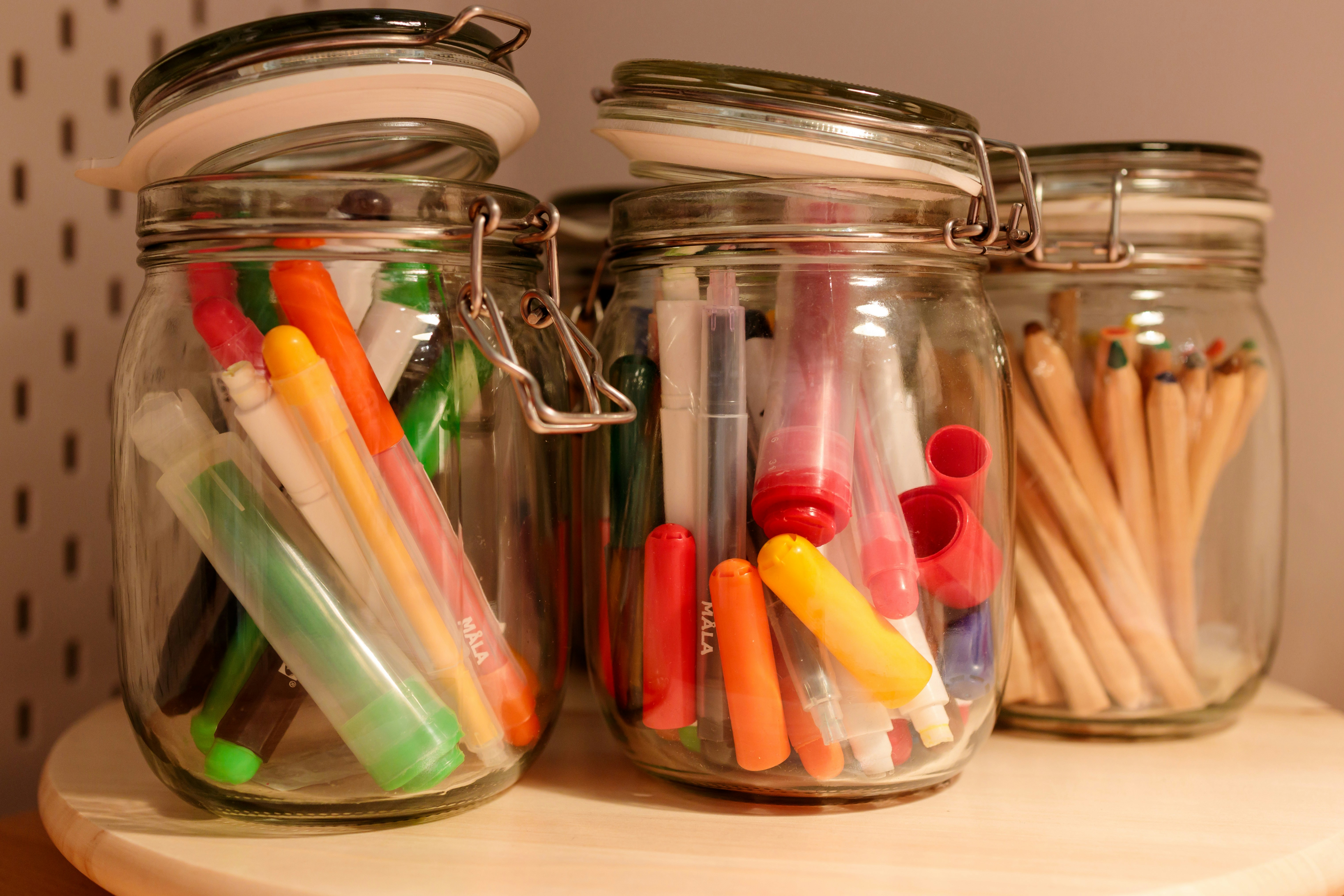 Colorful writing prompt cards spread on a desk with pencils and creative art materials