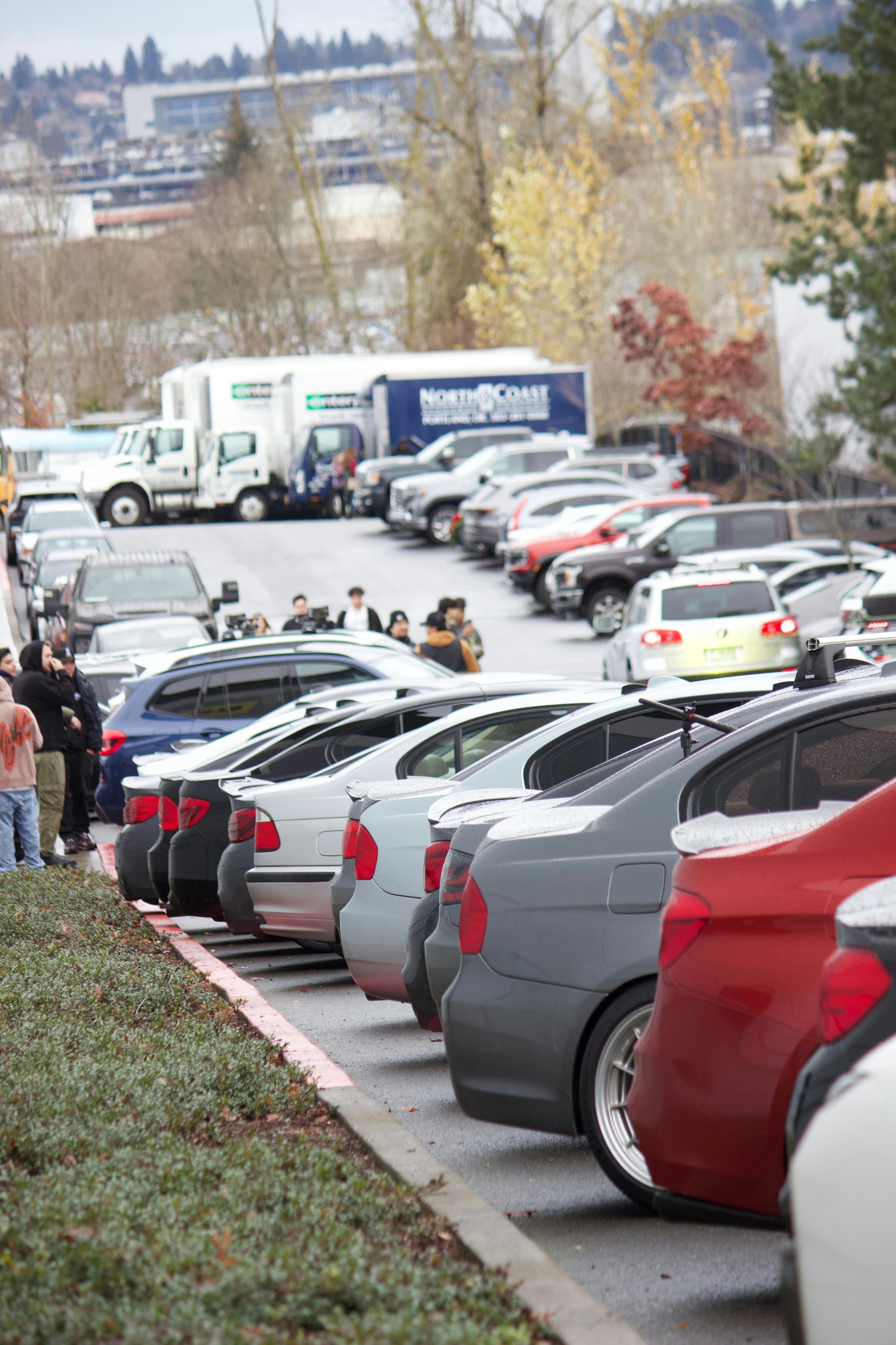Rows of vehicles parked in a car auction yard awaiting collection