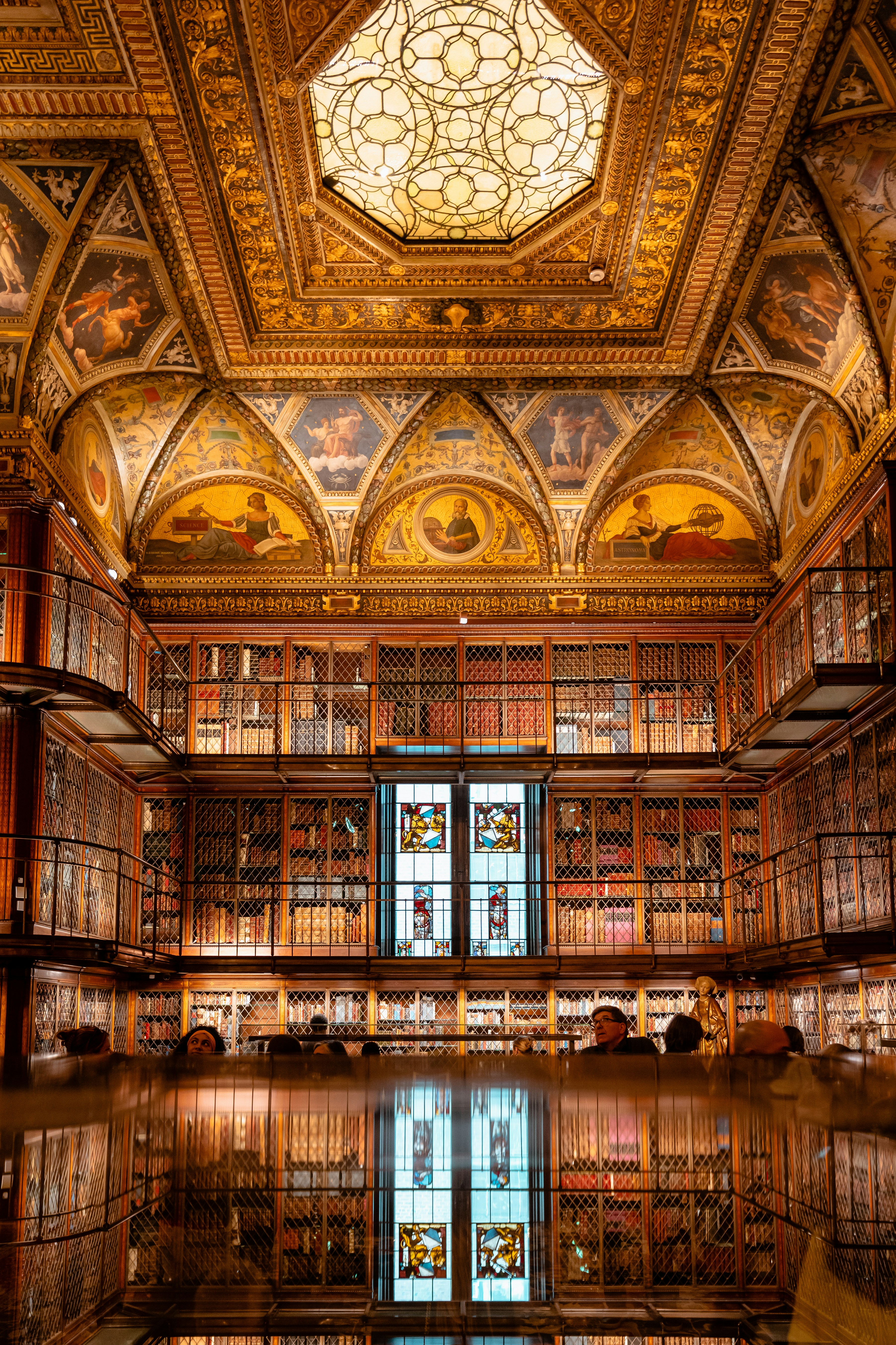 A large room with many bookshelves and a stained glass window