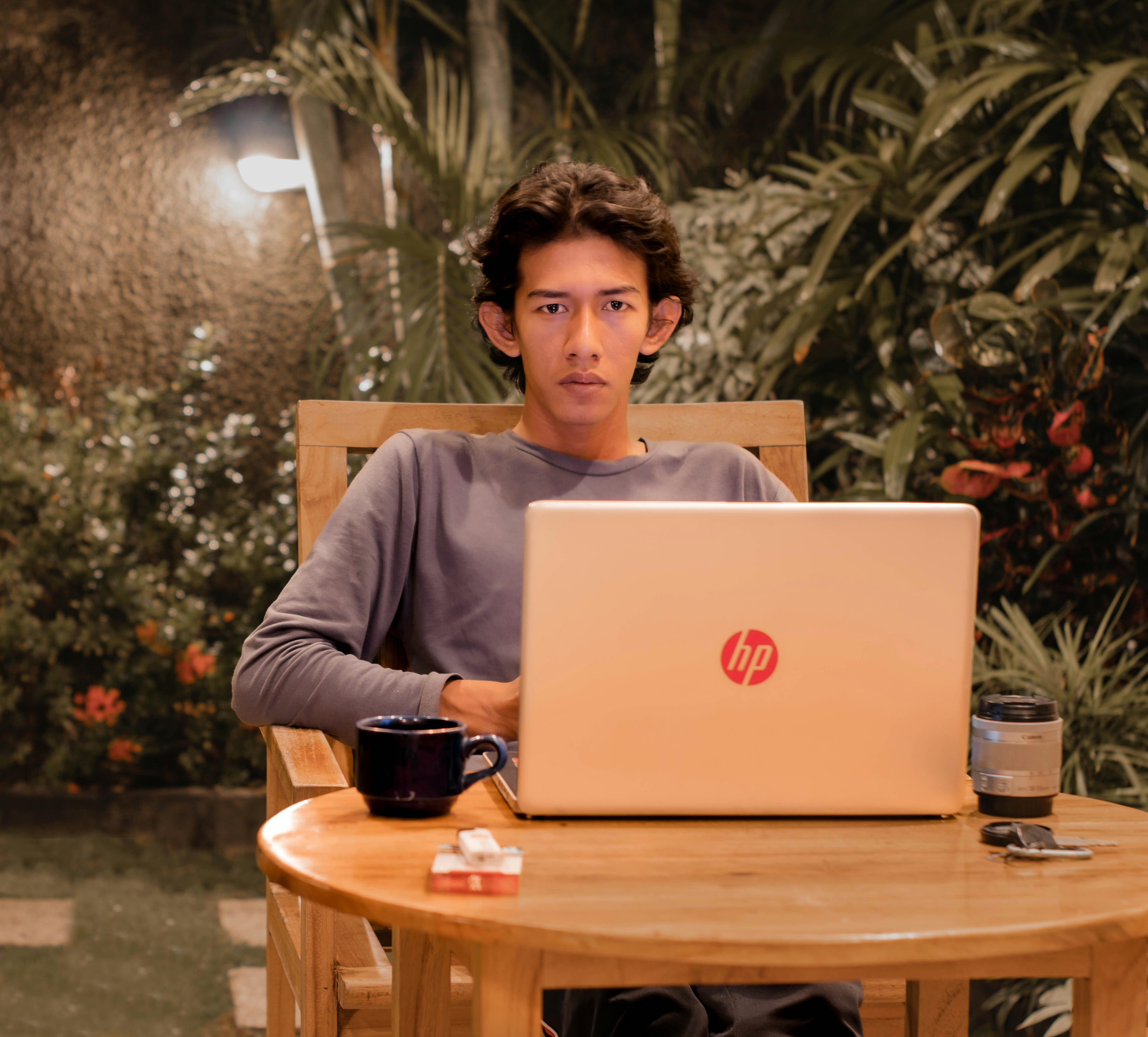 A man sitting at a table with a laptop