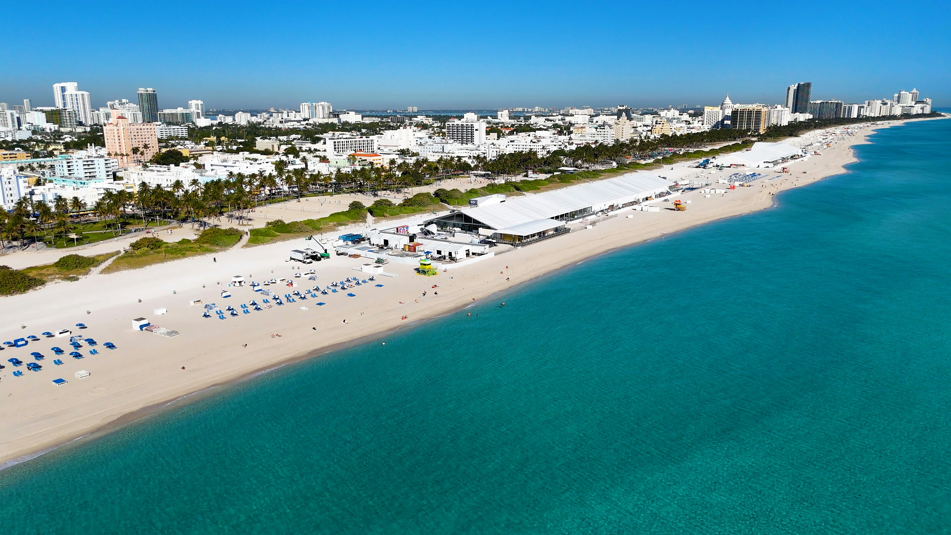 An aerial view of a beach with a city in the background (Photo by Michael Moloney on Unsplash)