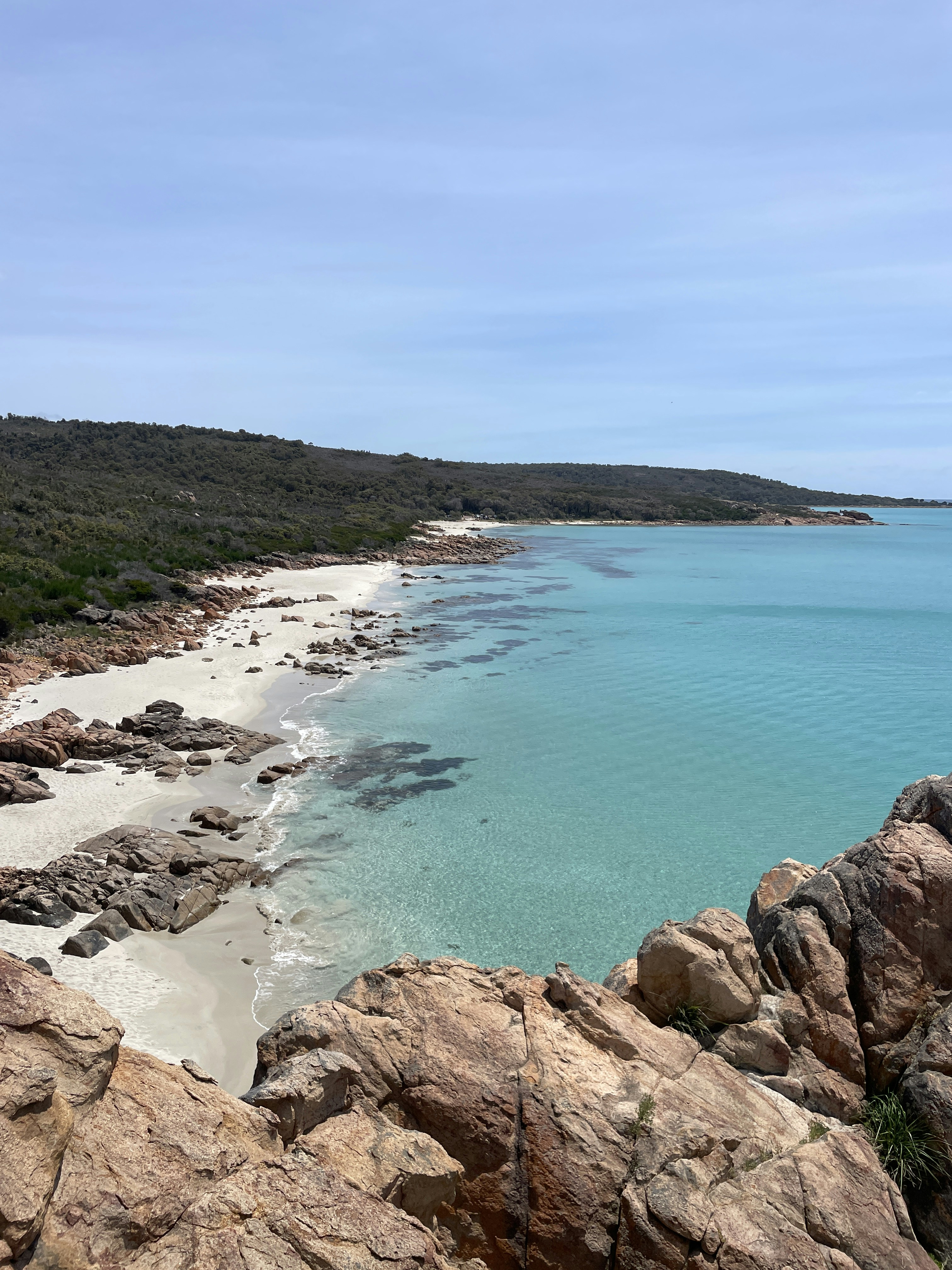 A view of a beach from a rocky outcropping