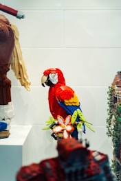 A parrot sitting on top of a white shelf
