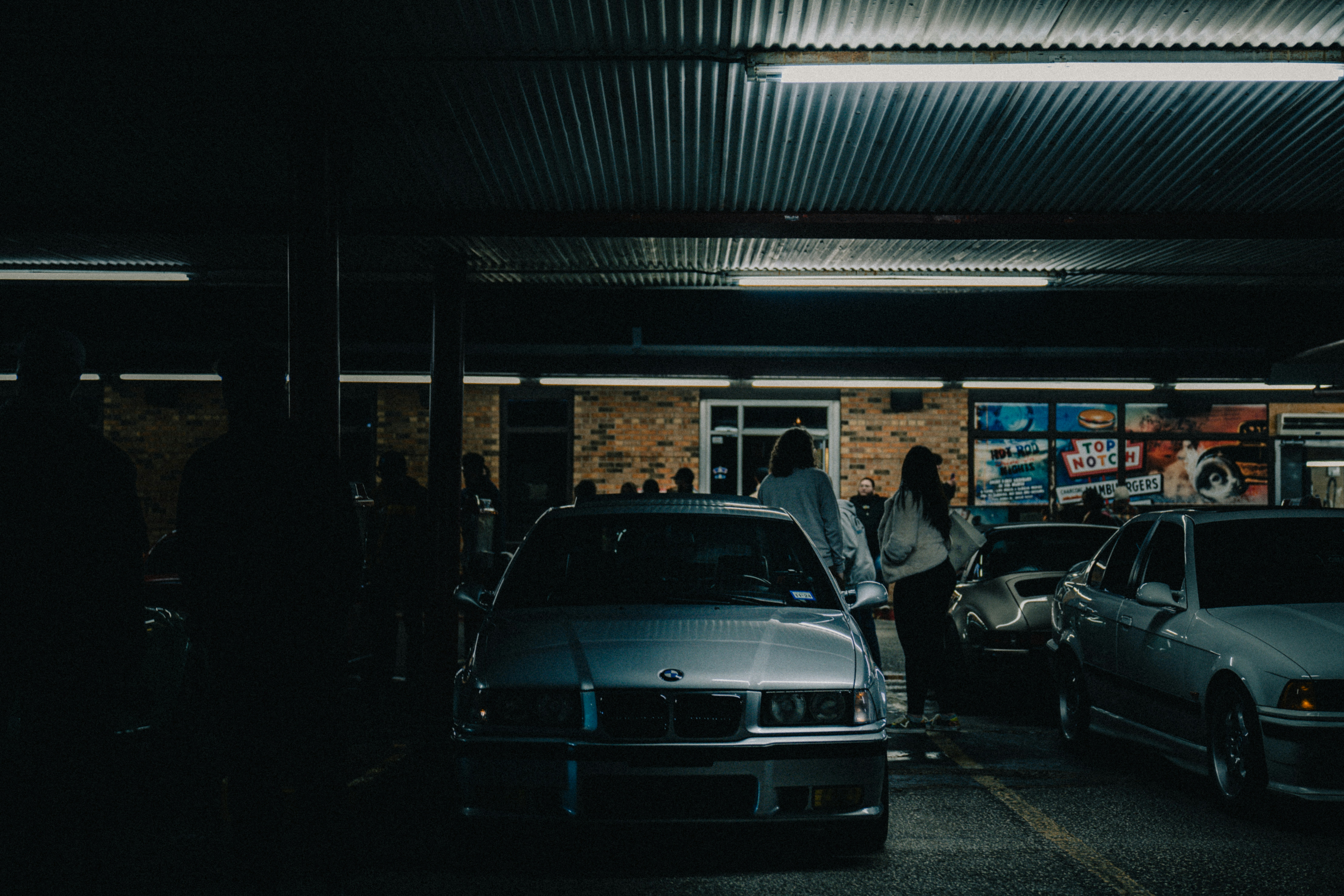 EV owner at a kitchen table reading through electric car battery warranty paperwork