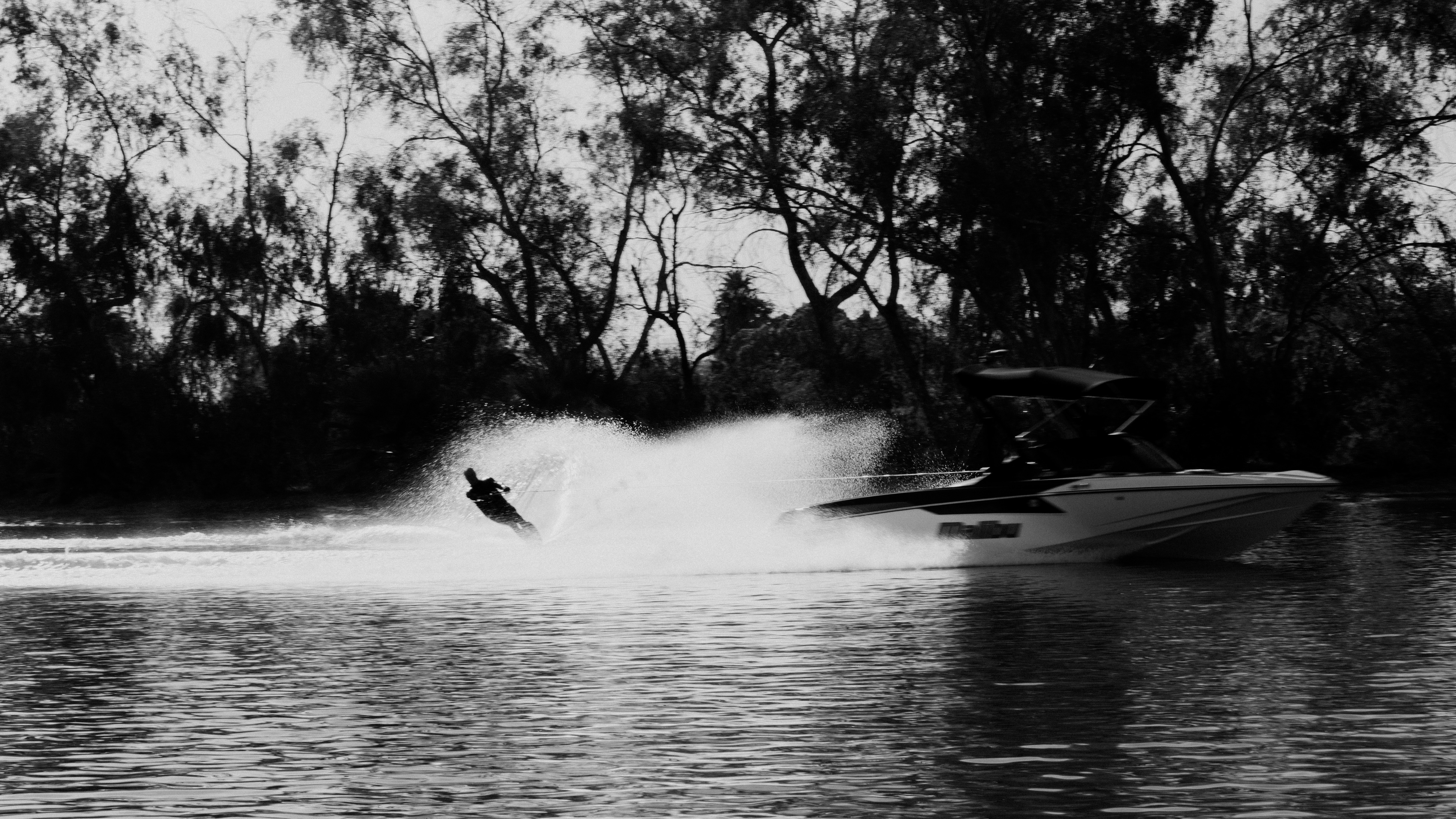 A person on a jet ski being pulled by a boat