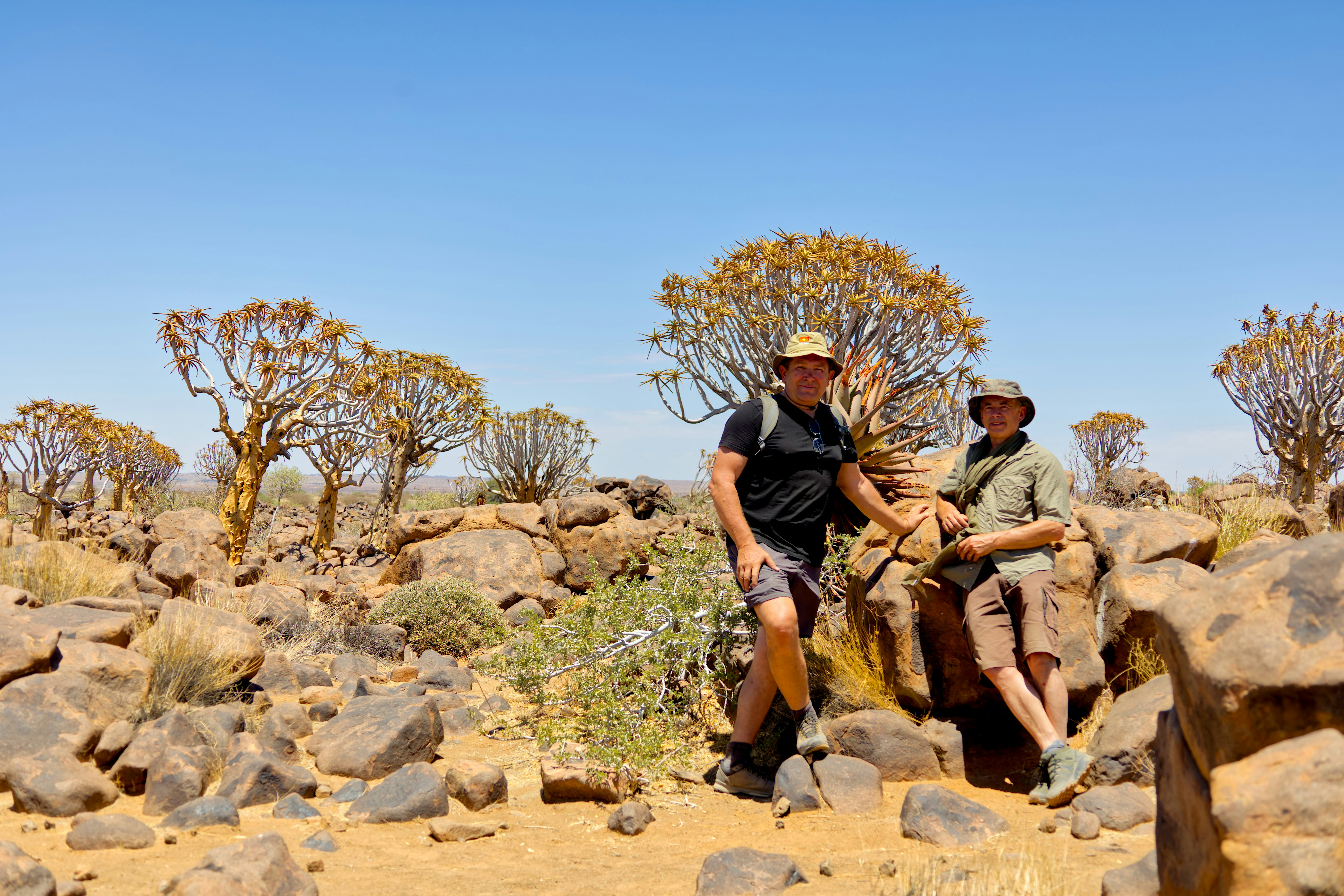A couple of men riding on the back of an elephant