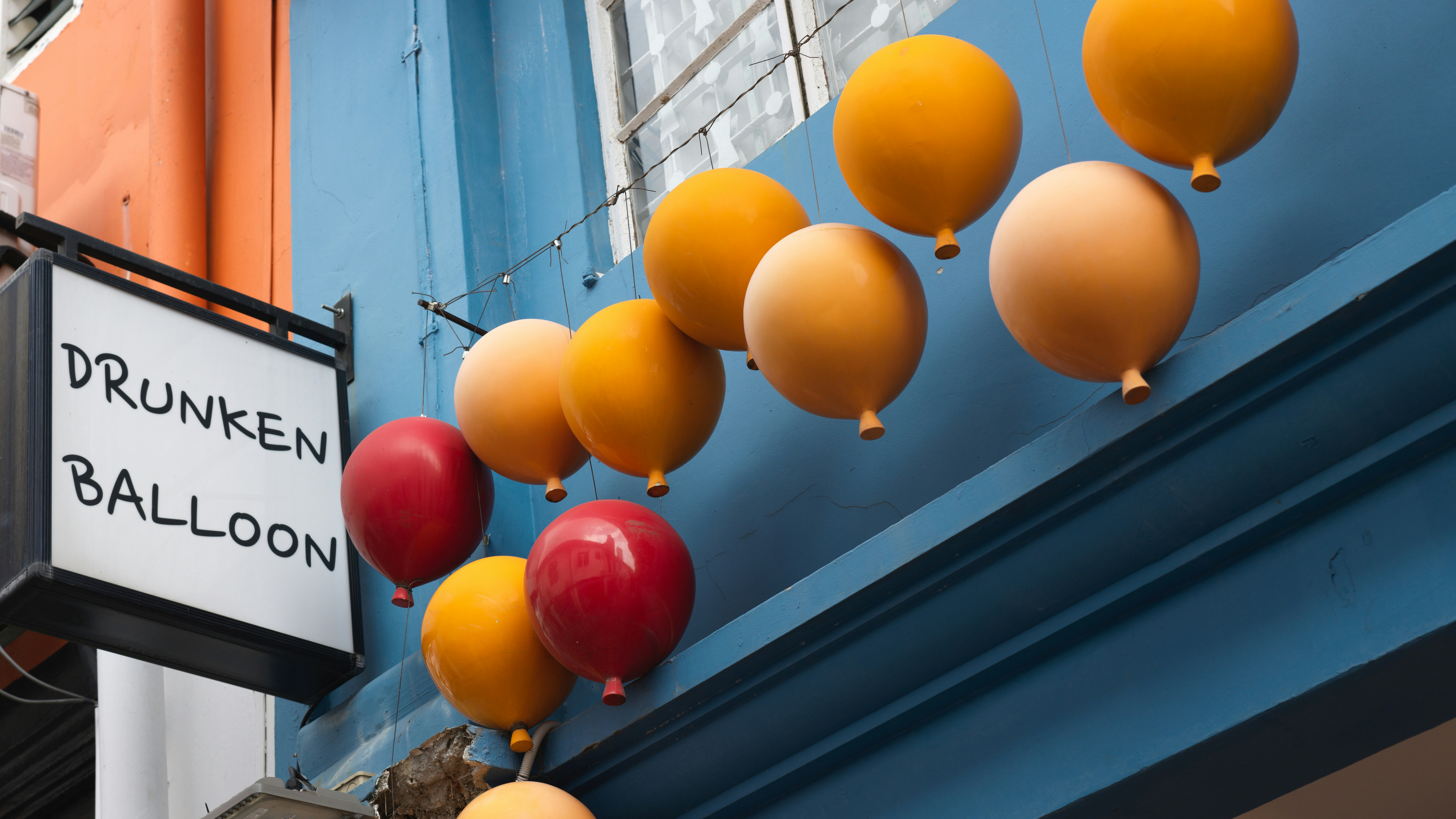 A street sign hanging from the side of a building