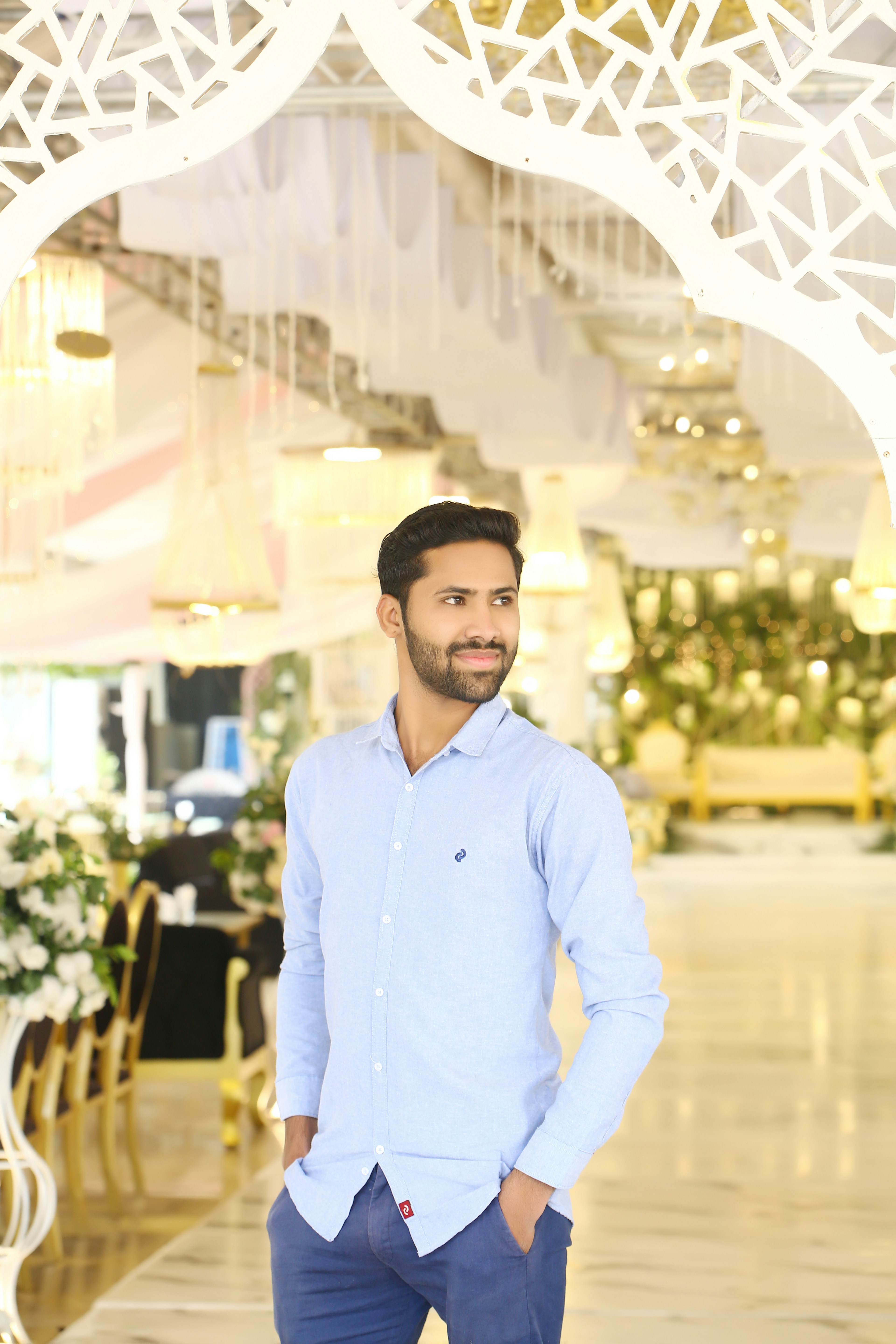 A man in a blue shirt standing in a room