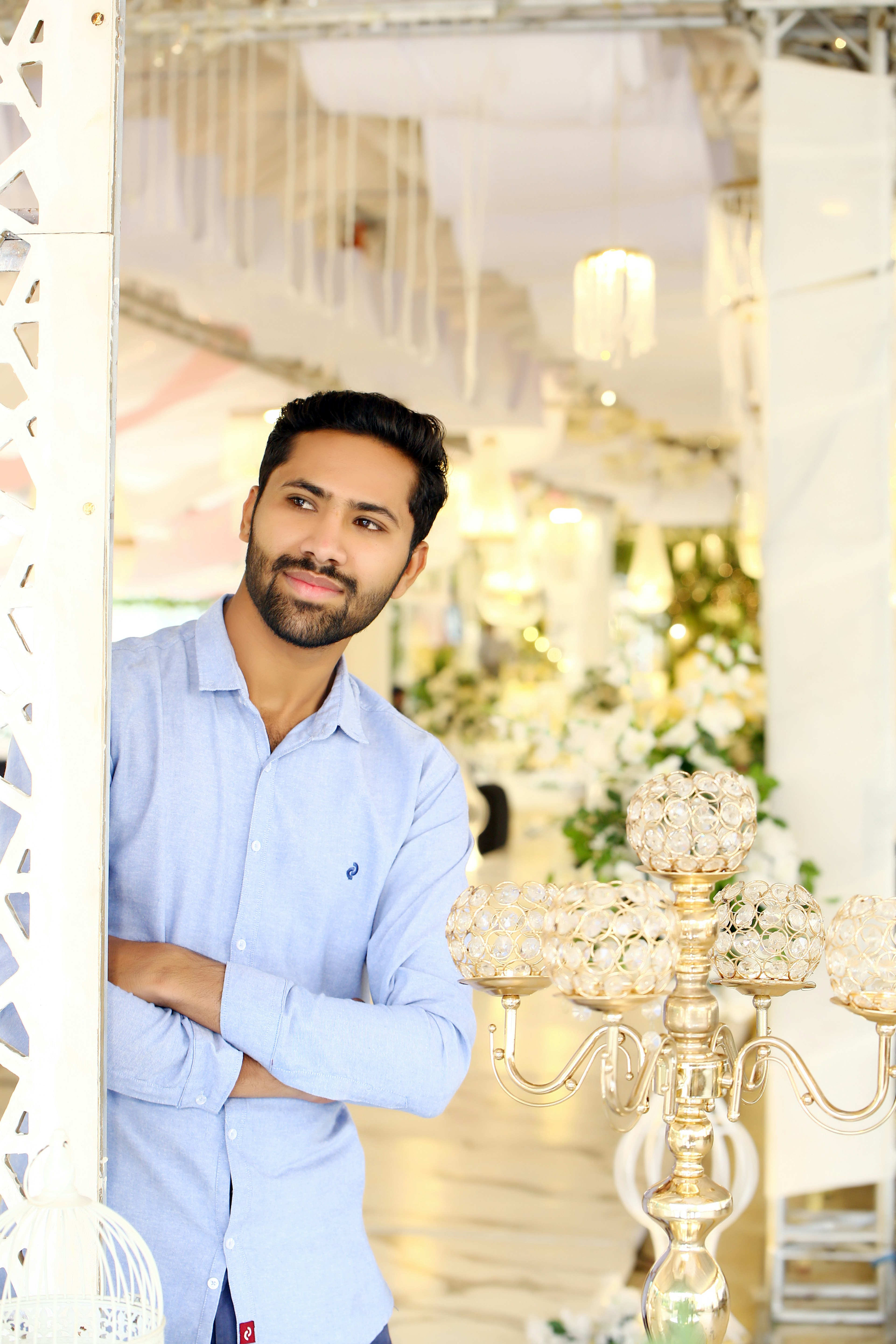 A man standing in front of a chandelier