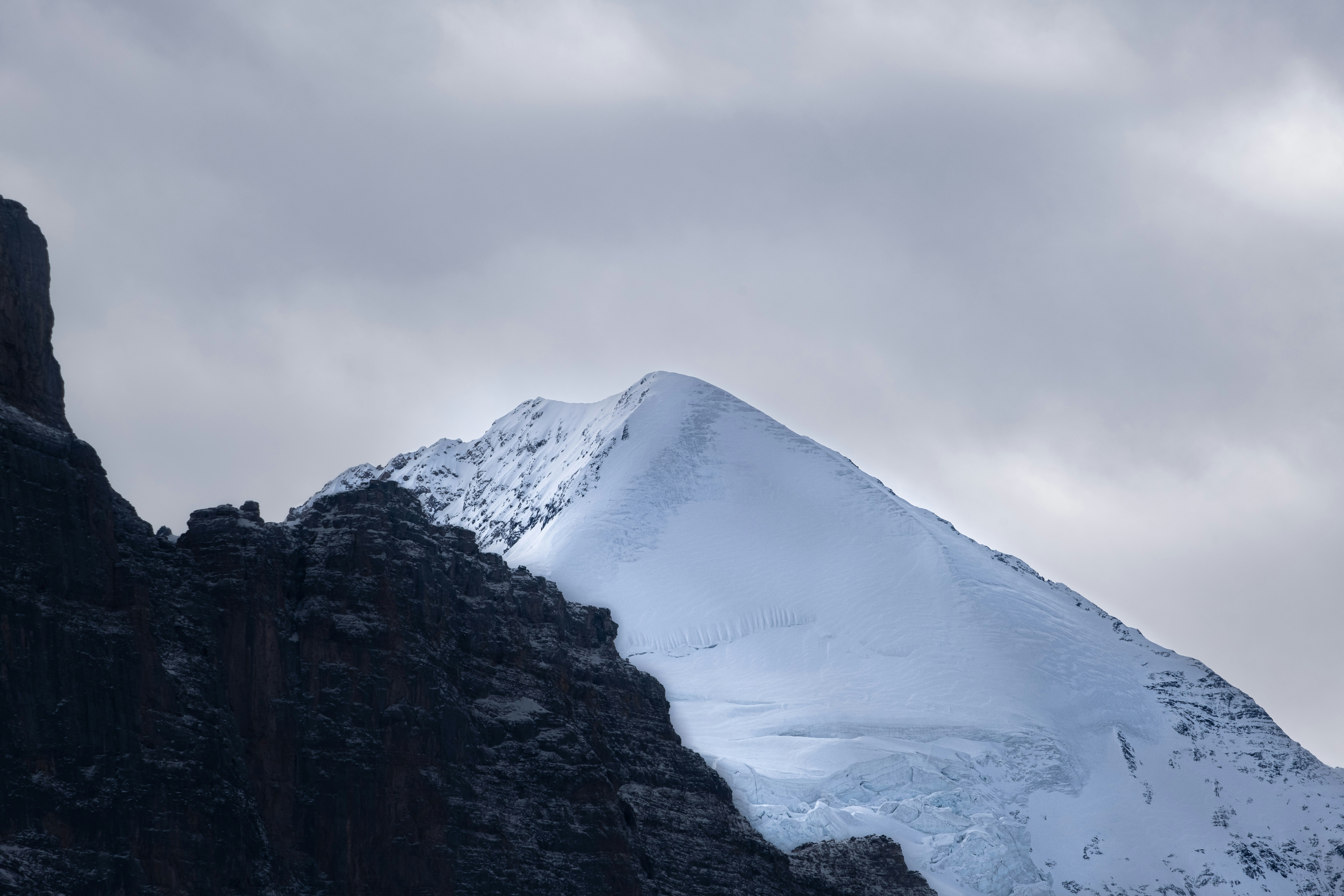 A mountain with a snow covered peak in the distance