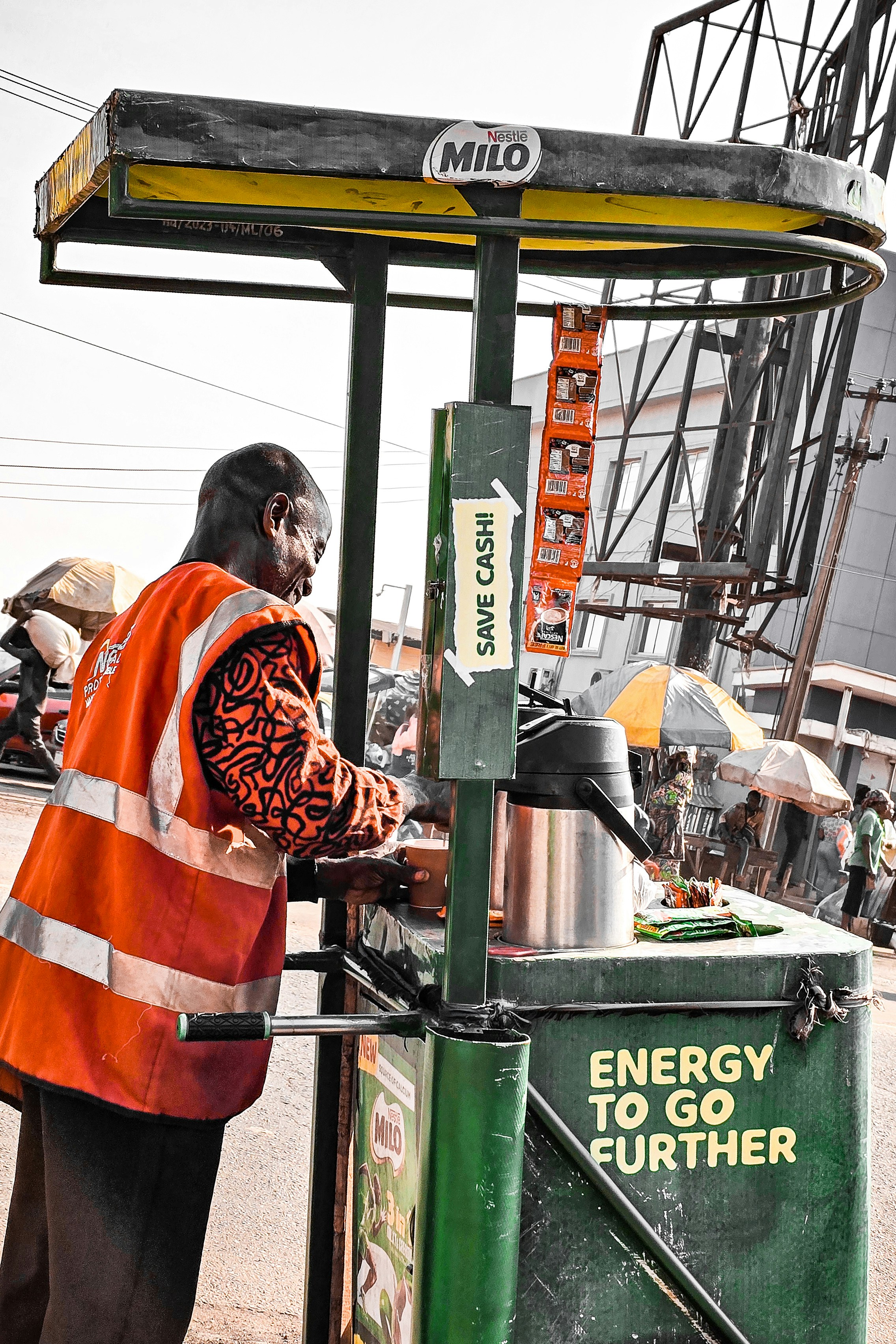 A man standing next to a green machine