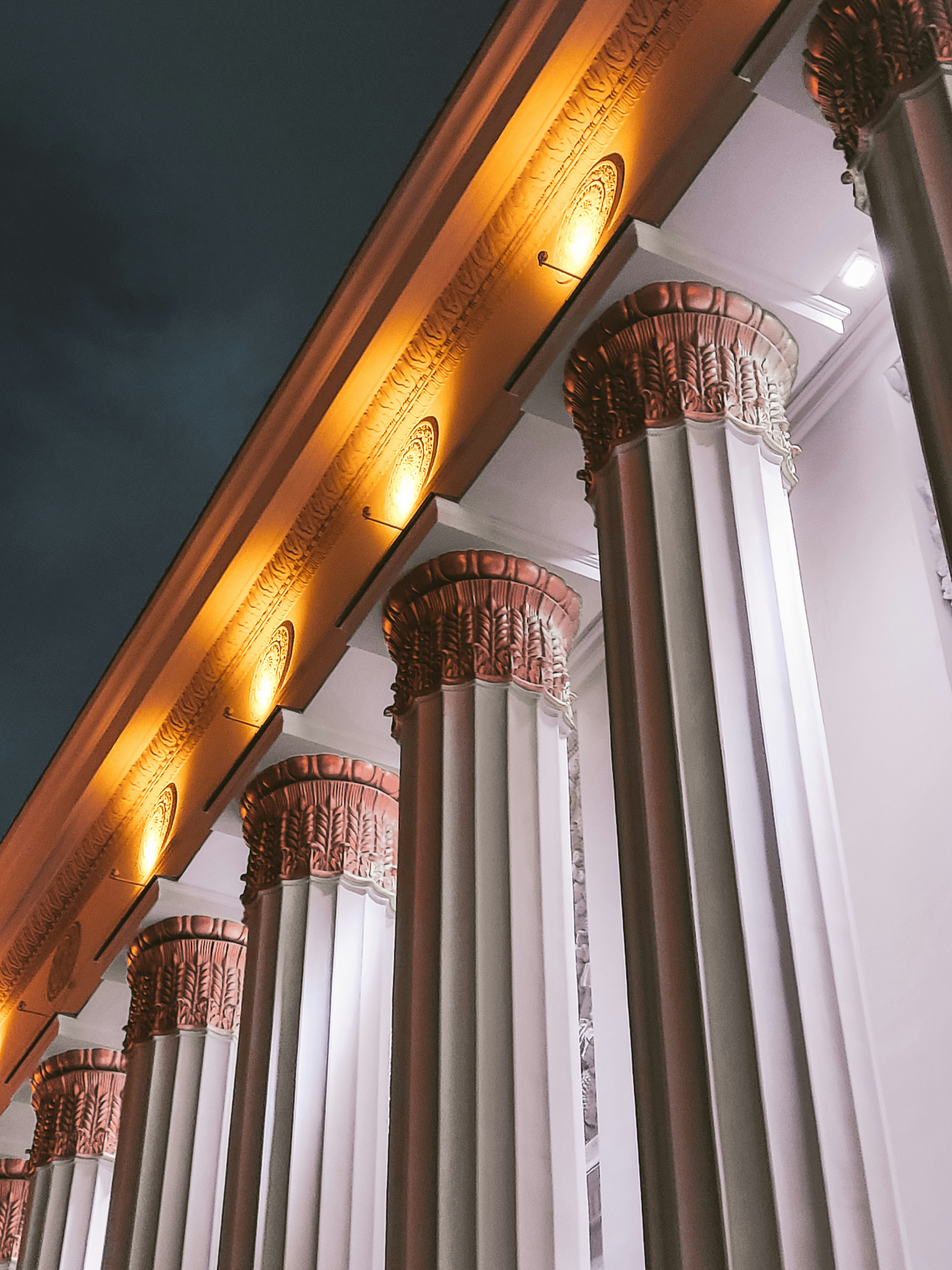 A row of white pillars lit up at night