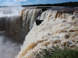 A large waterfall with water pouring out of it