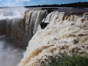 A large waterfall with water pouring out of it