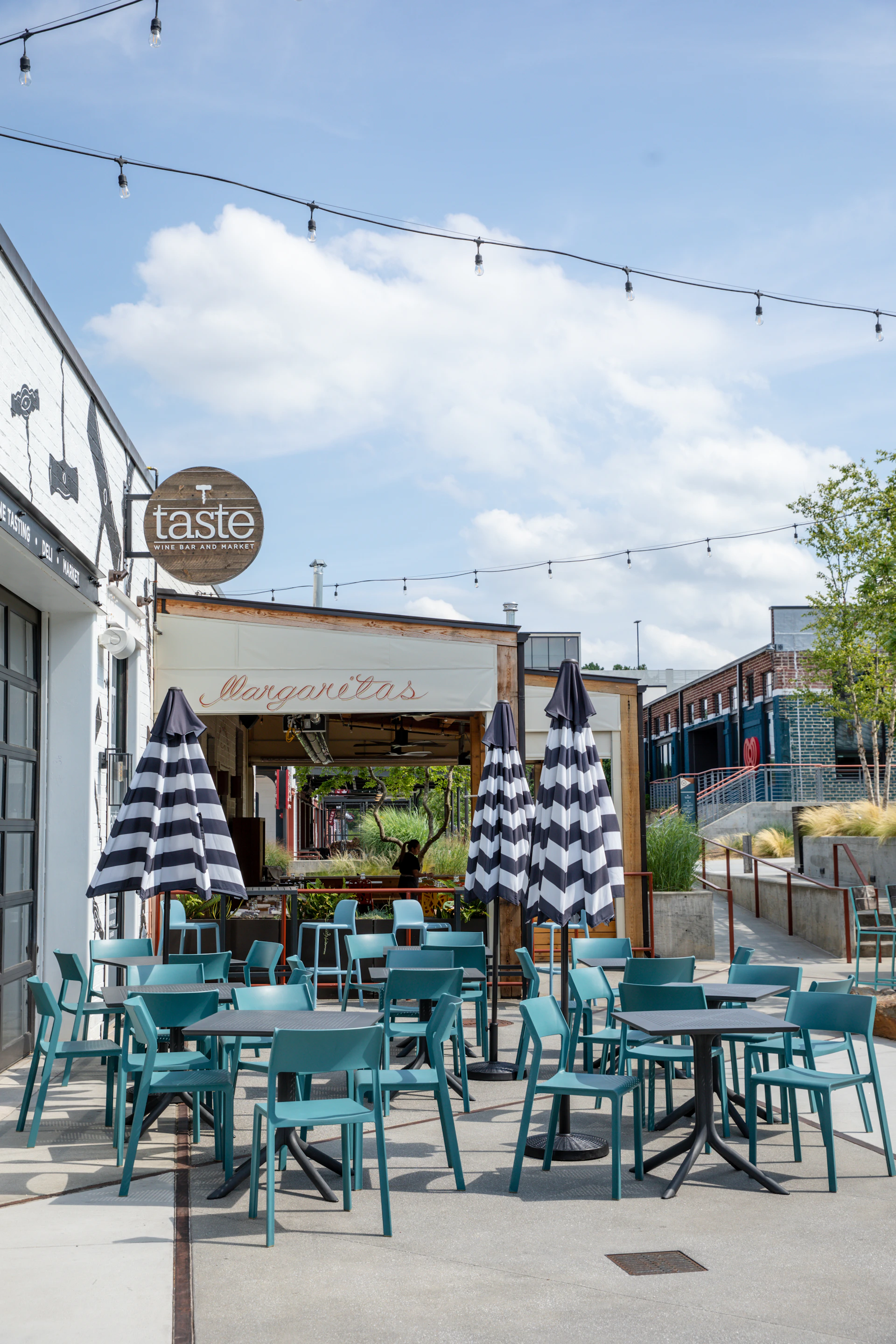 Tables and chairs outside of a restaurant on a sunny day