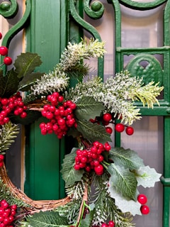 A green door with a wreath on it
