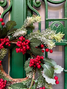 A green door with a wreath on it