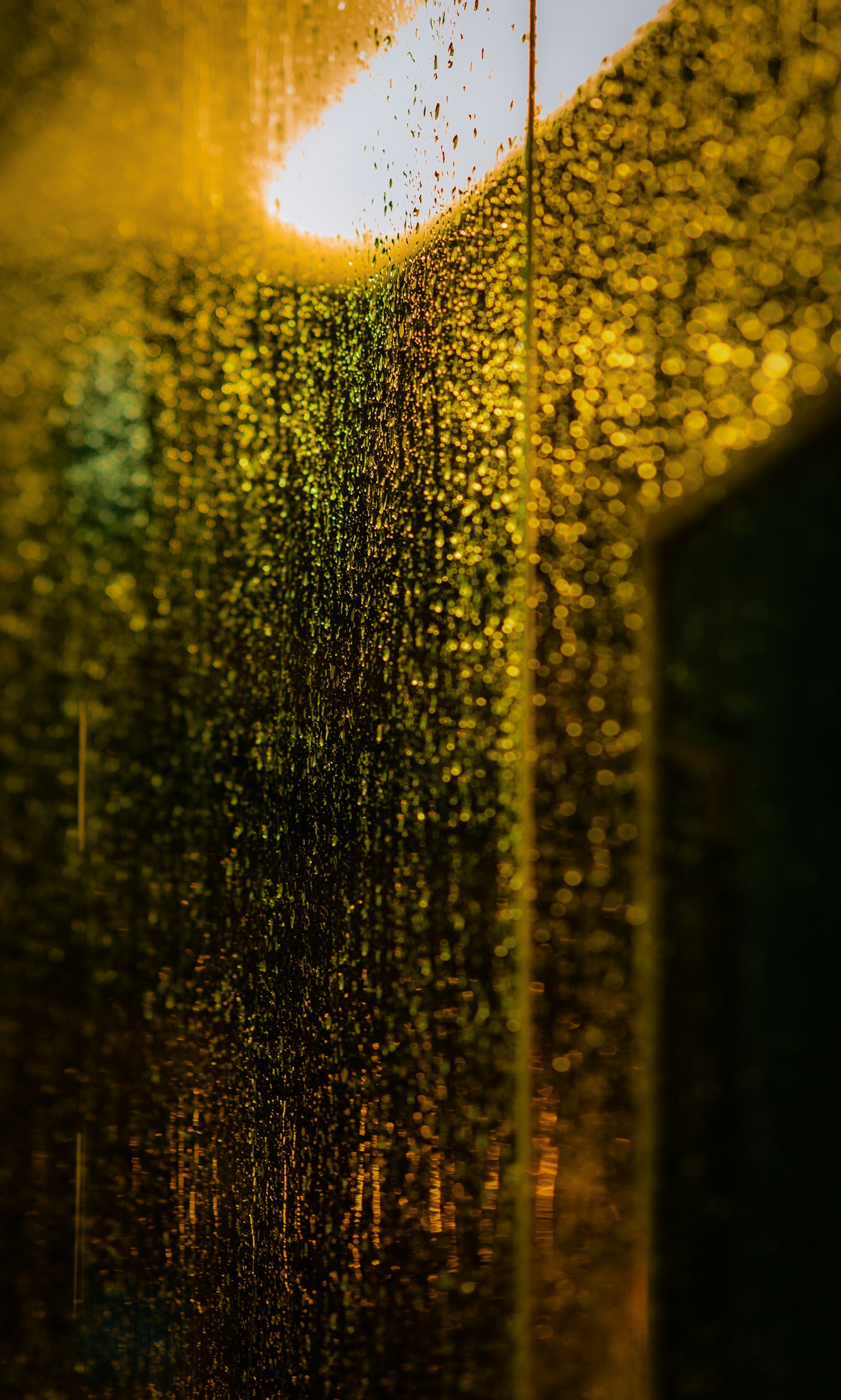 Rain streaking down a window, storm outside