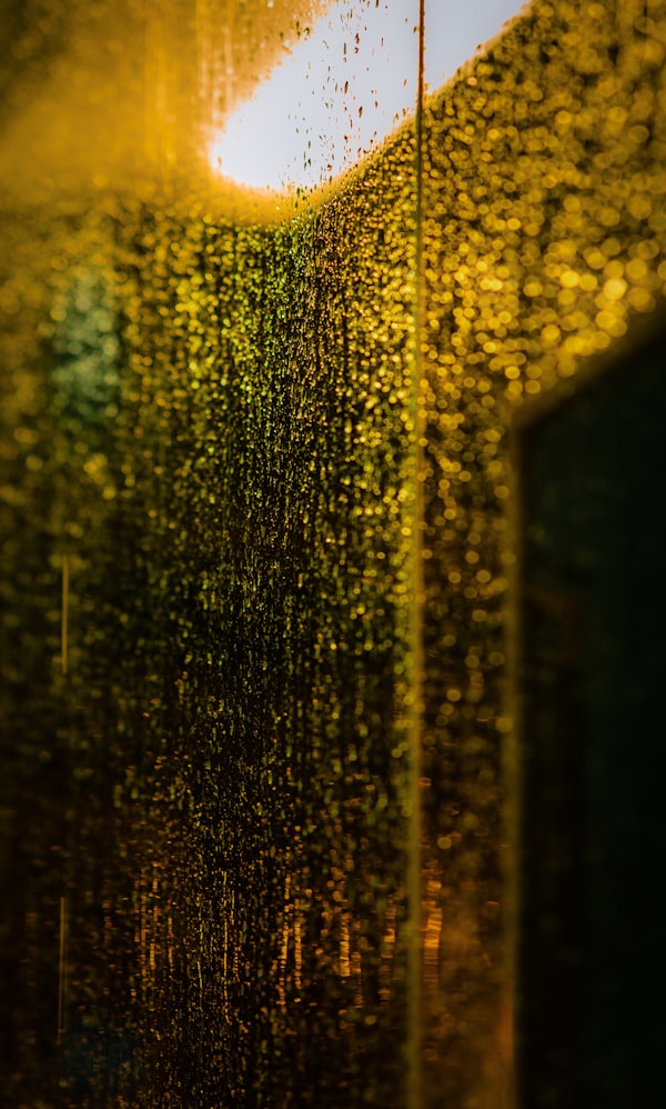 Rain streaking down a window, storm outside