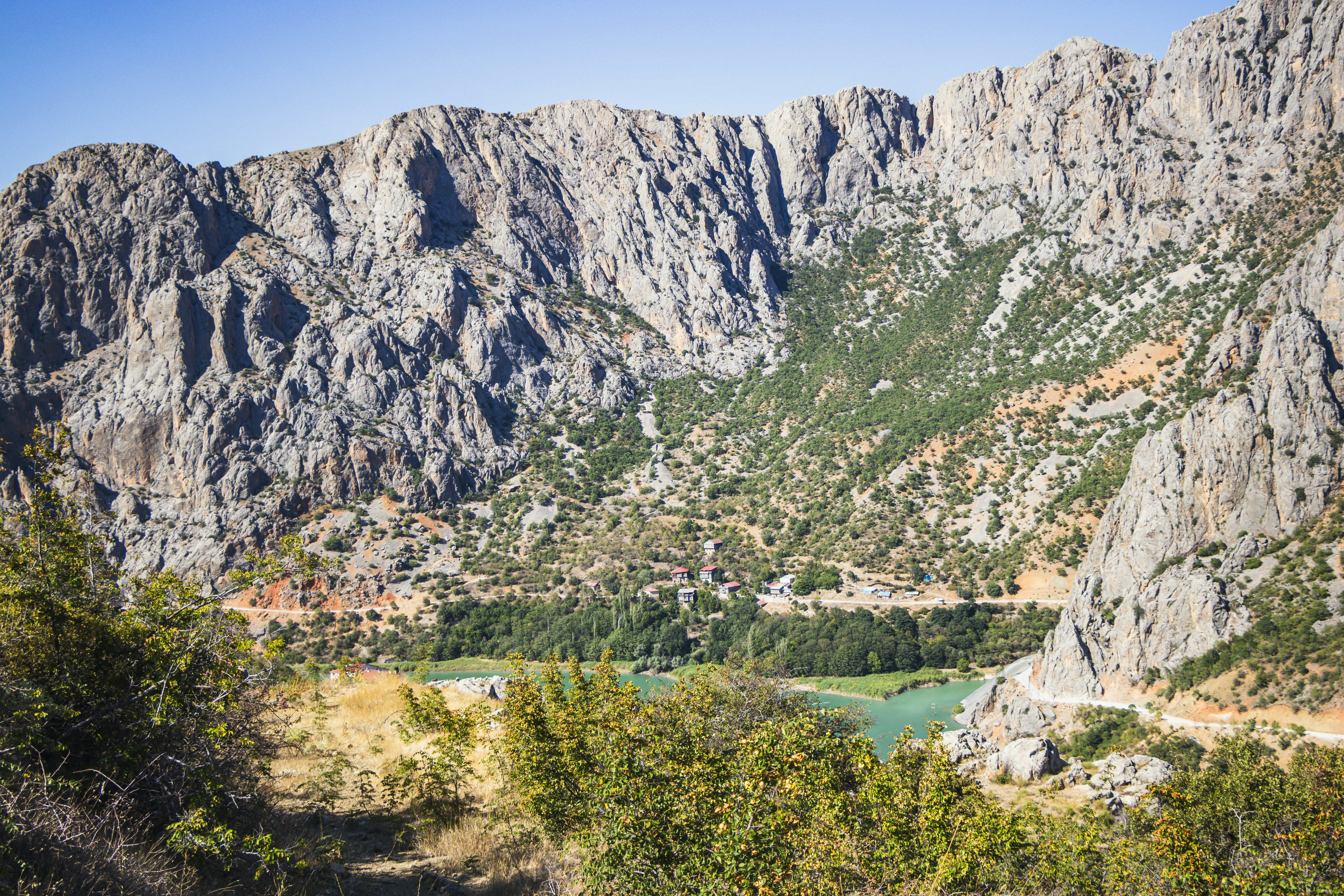 A view of a mountain range with a lake in the foreground