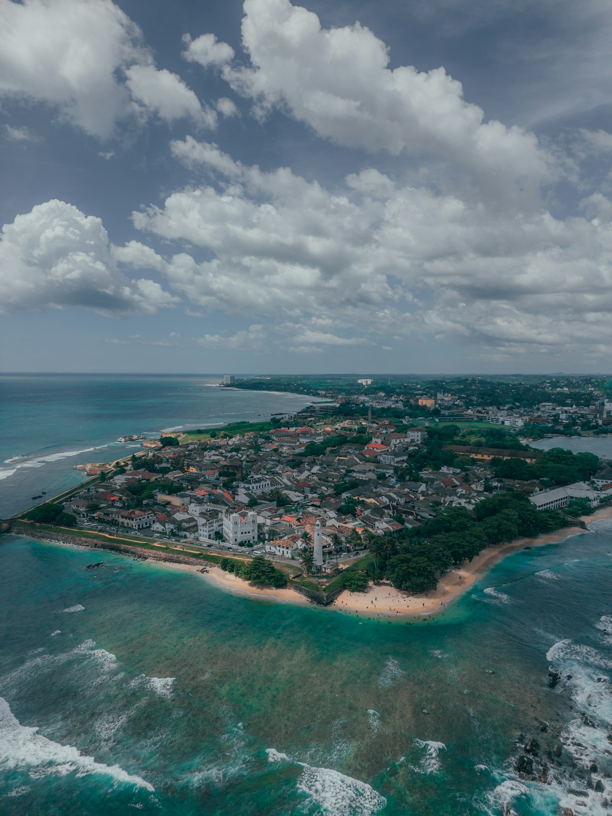 Unawatuna beach, Sri Lanka - sheltered turquoise bay surrounded by palm trees and green hills